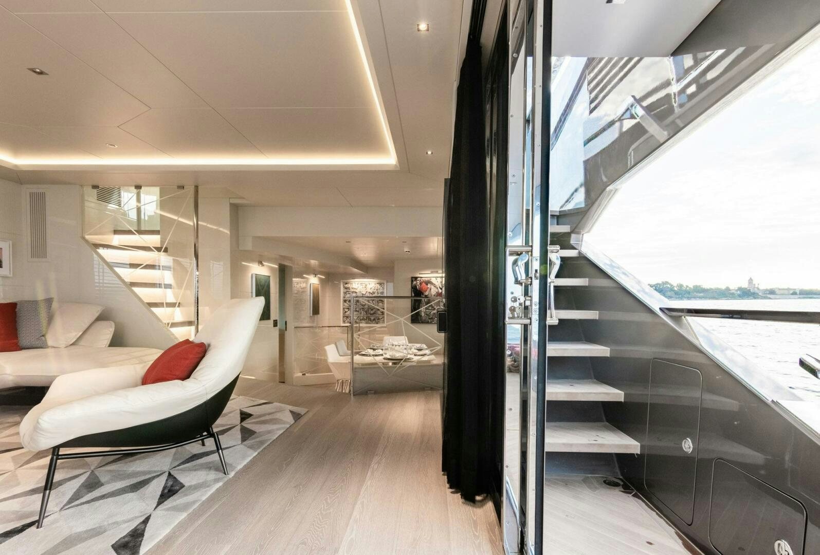 a room with a large window and a view of the water aboard BEACH CLUB Yacht for Sale