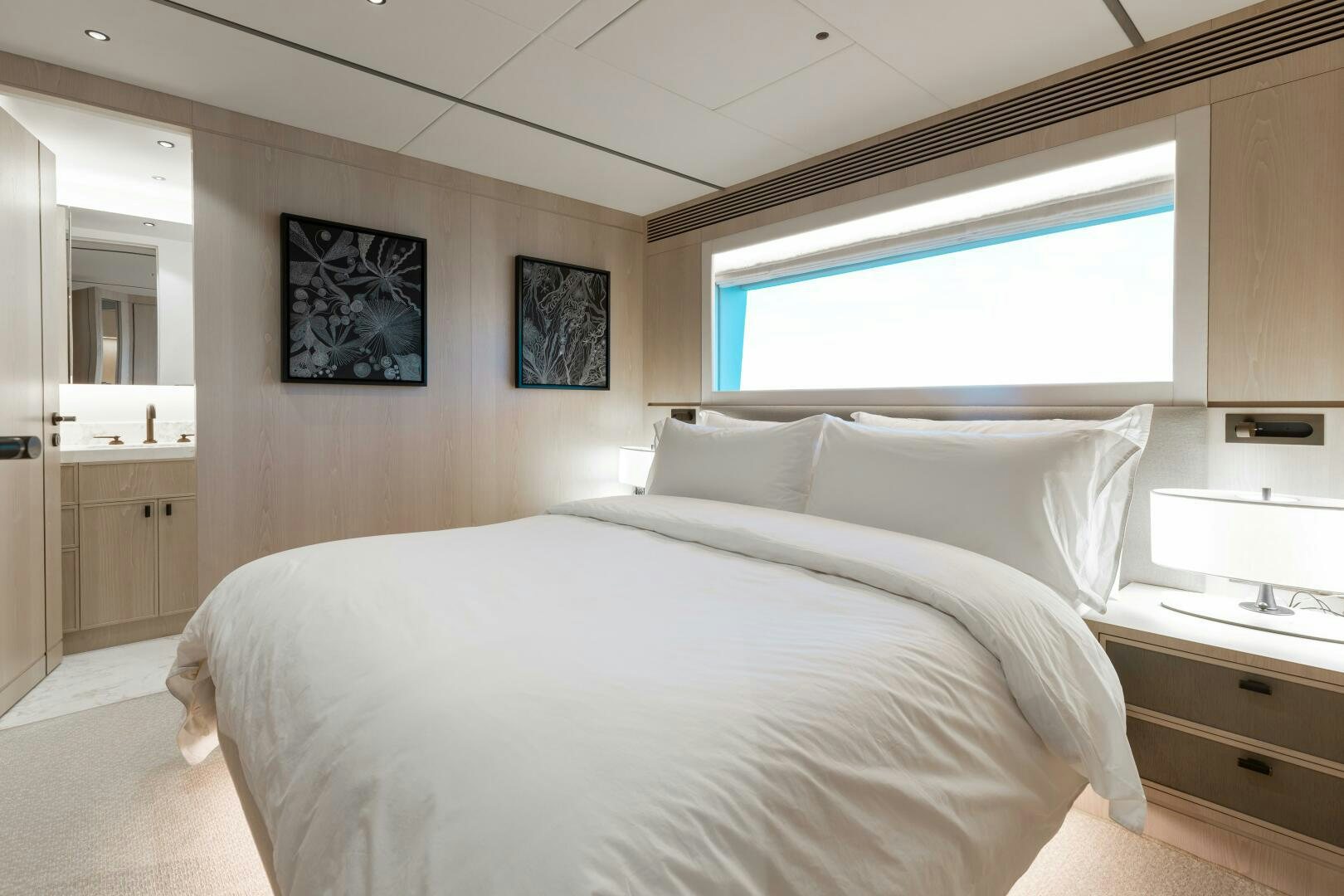 a bed with white sheets aboard UNTETHERED Yacht for Sale