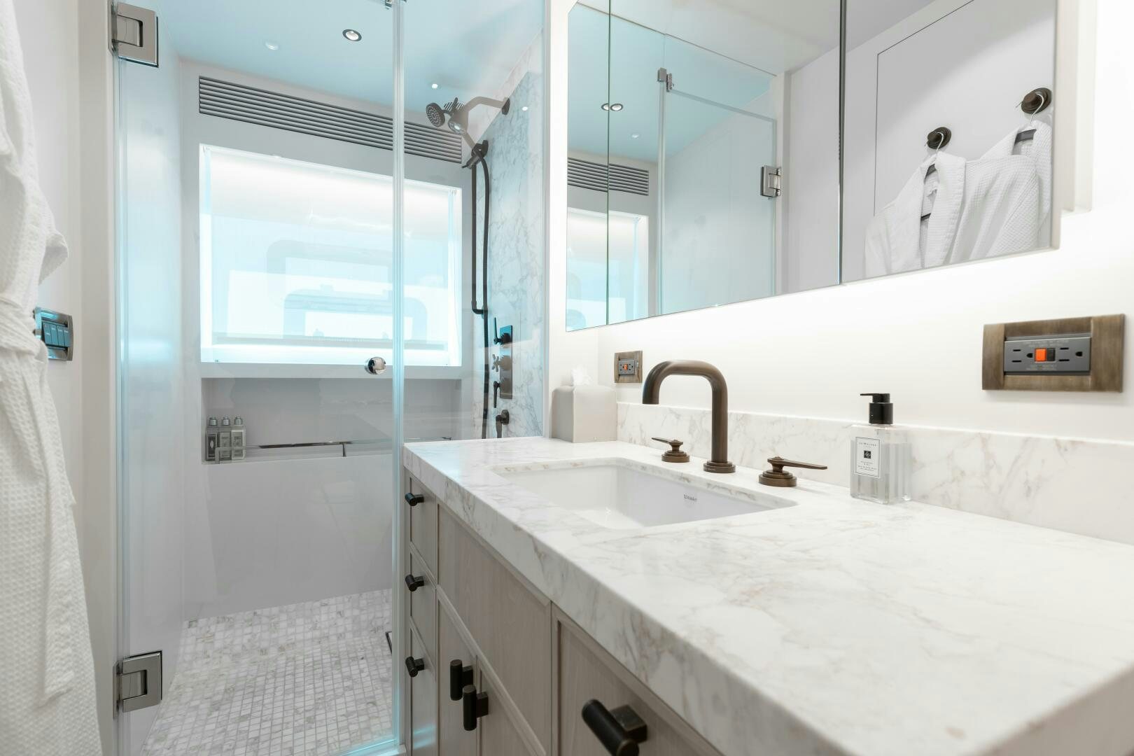 a bathroom with a sink and a mirror aboard UNTETHERED Yacht for Sale