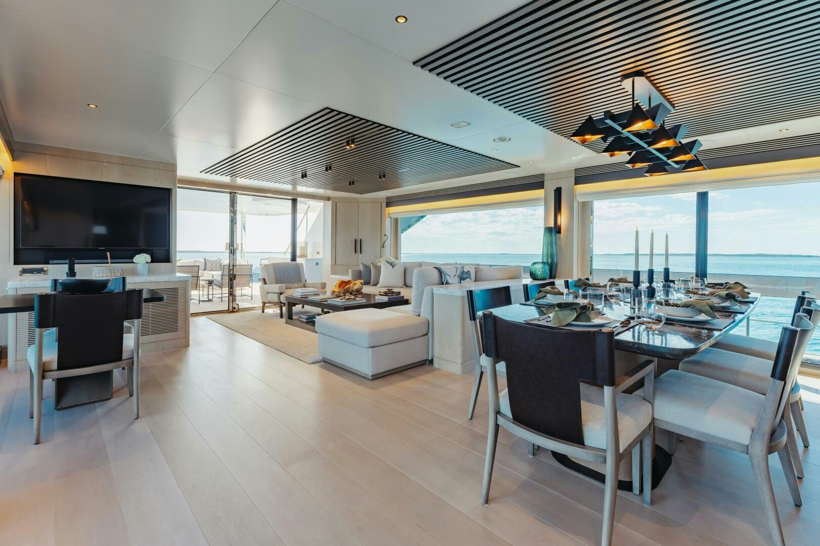 a large room with a table and chairs aboard UNTETHERED Yacht for Sale