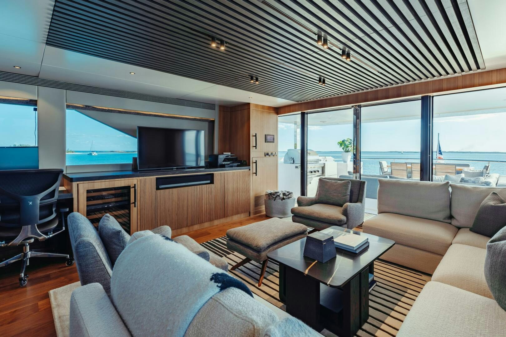 a living room with a large window aboard UNTETHERED Yacht for Sale