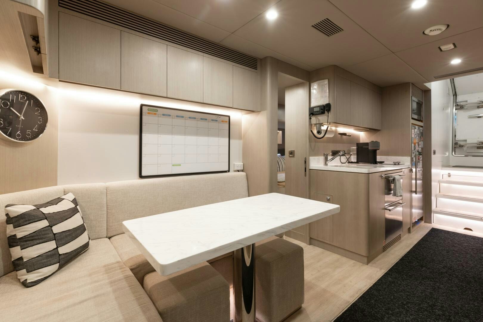 a large kitchen with a table and chairs aboard UNTETHERED Yacht for Sale