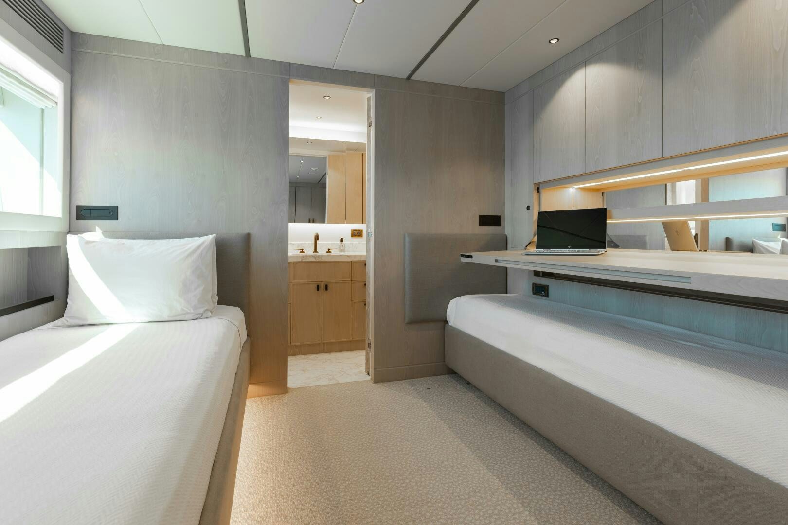 a room with a bed and a desk aboard UNTETHERED Yacht for Sale