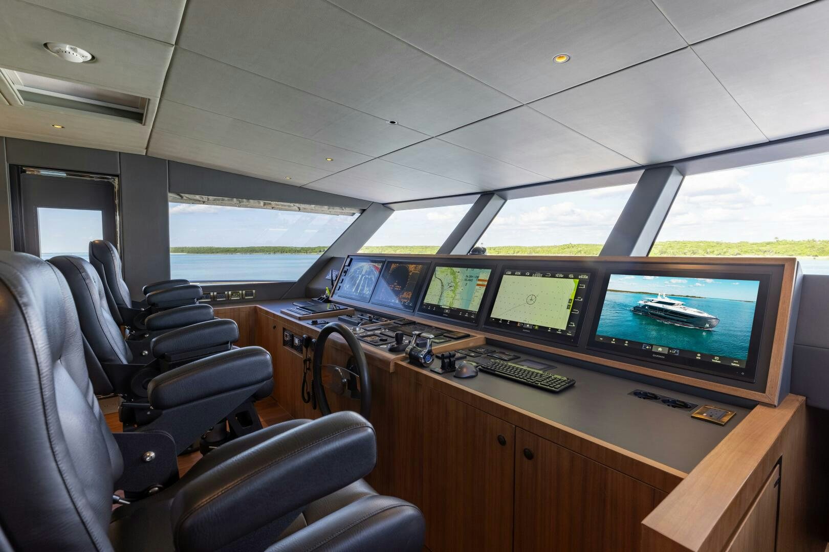 a control room with several monitors aboard UNTETHERED Yacht for Sale