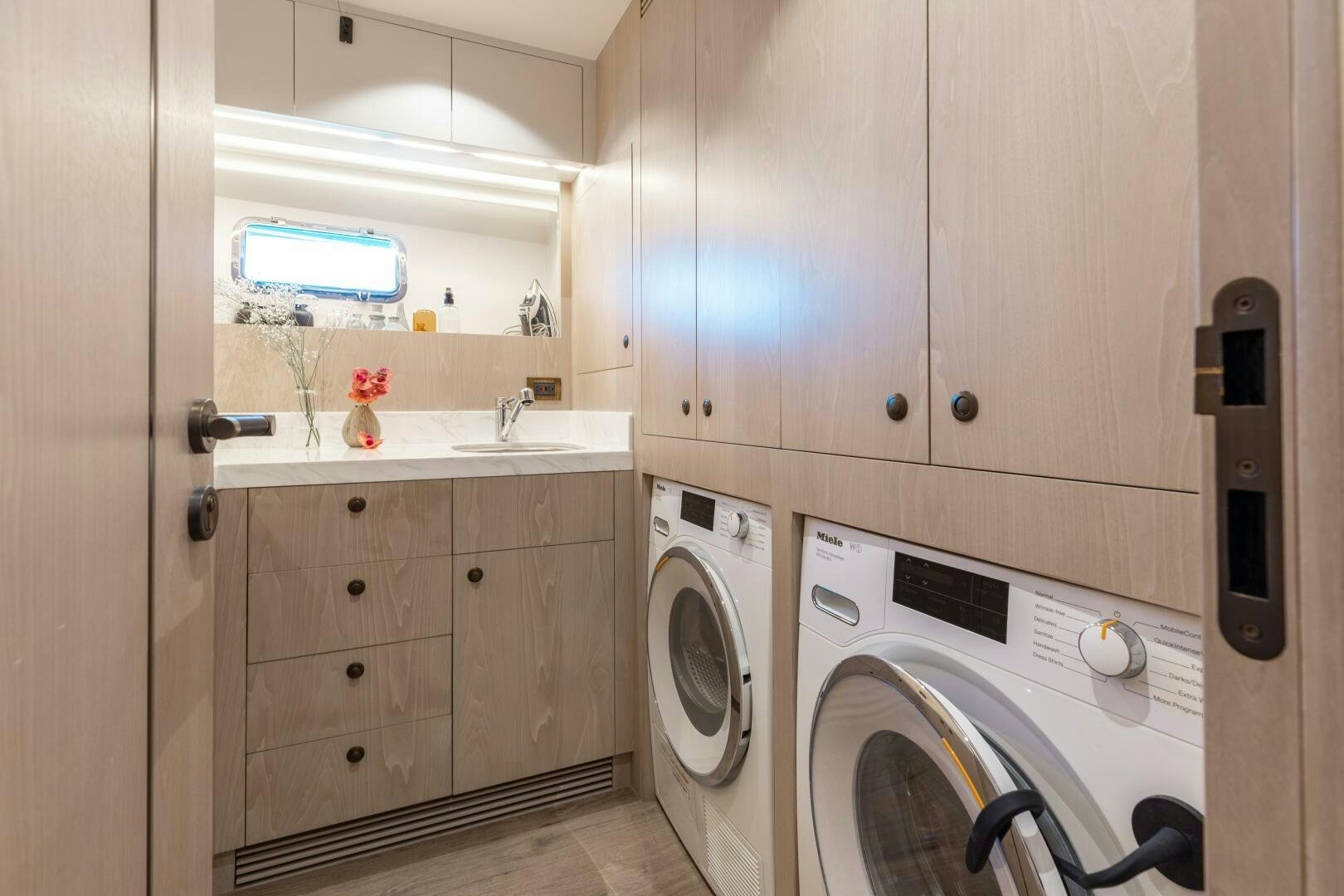 a washer and dryer in a laundry room aboard UNTETHERED Yacht for Sale