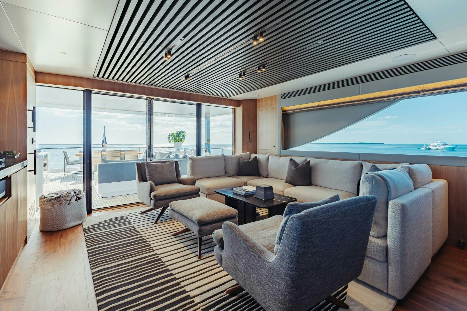 a living room with a large window aboard UNTETHERED Yacht for Sale