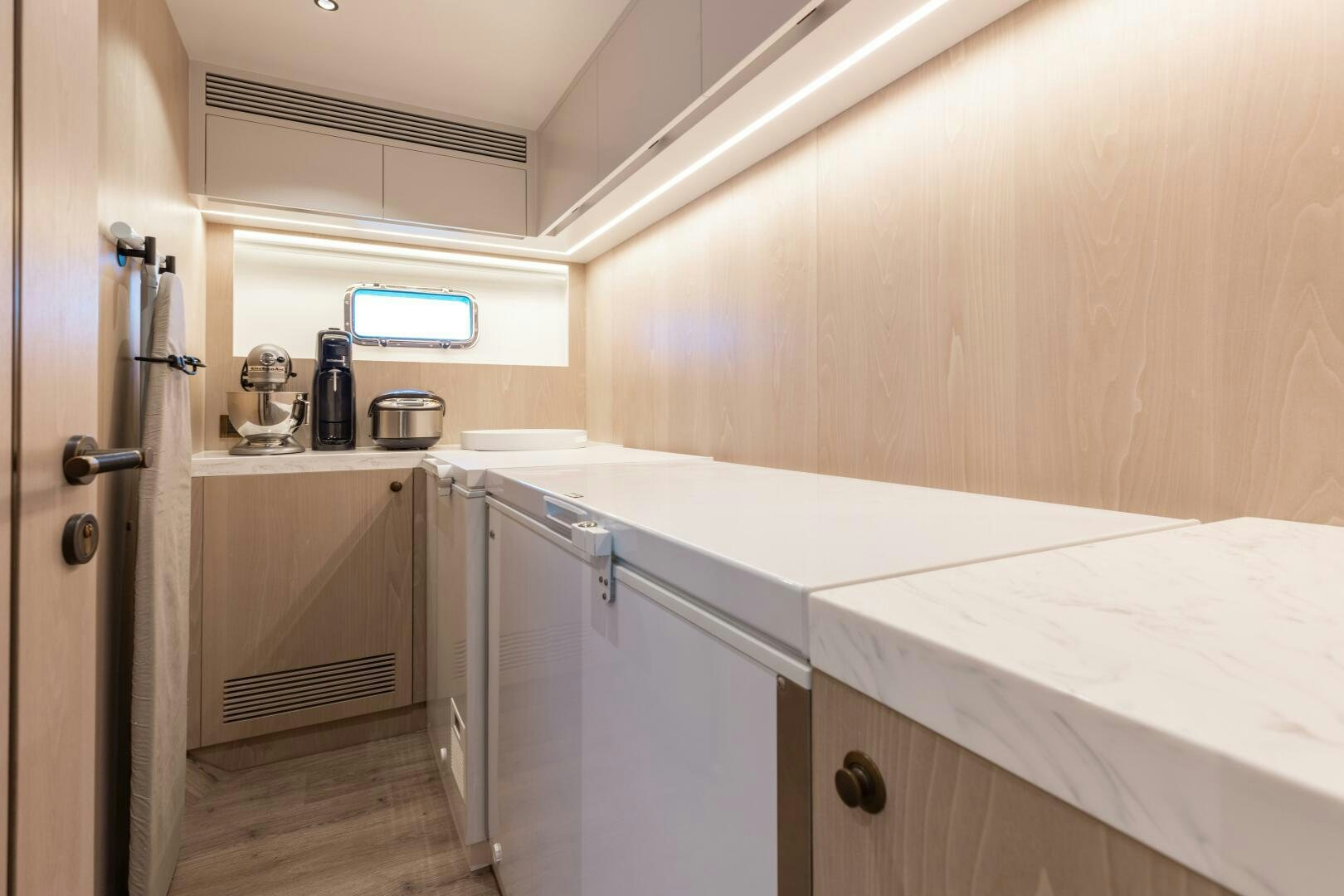 a kitchen with white cabinets aboard UNTETHERED Yacht for Sale