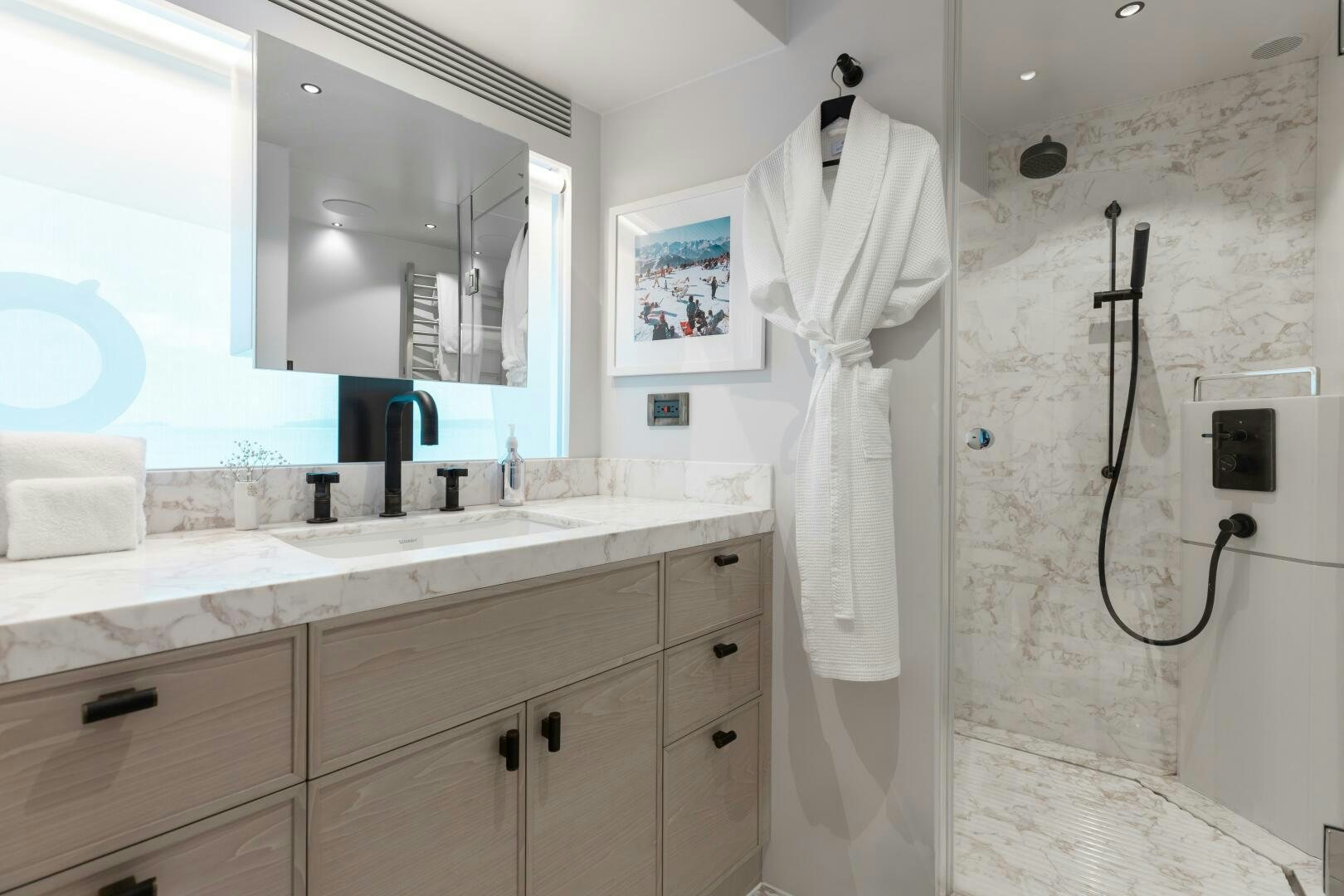 a bathroom with a robe on the wall aboard UNTETHERED Yacht for Sale