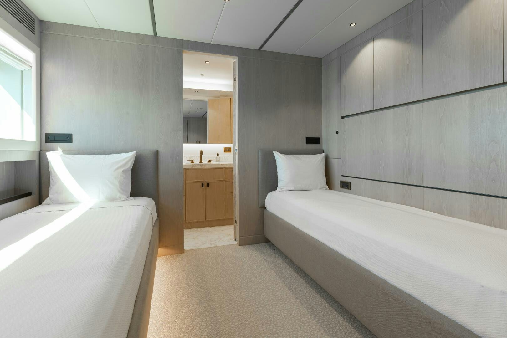 a room with two beds aboard UNTETHERED Yacht for Sale