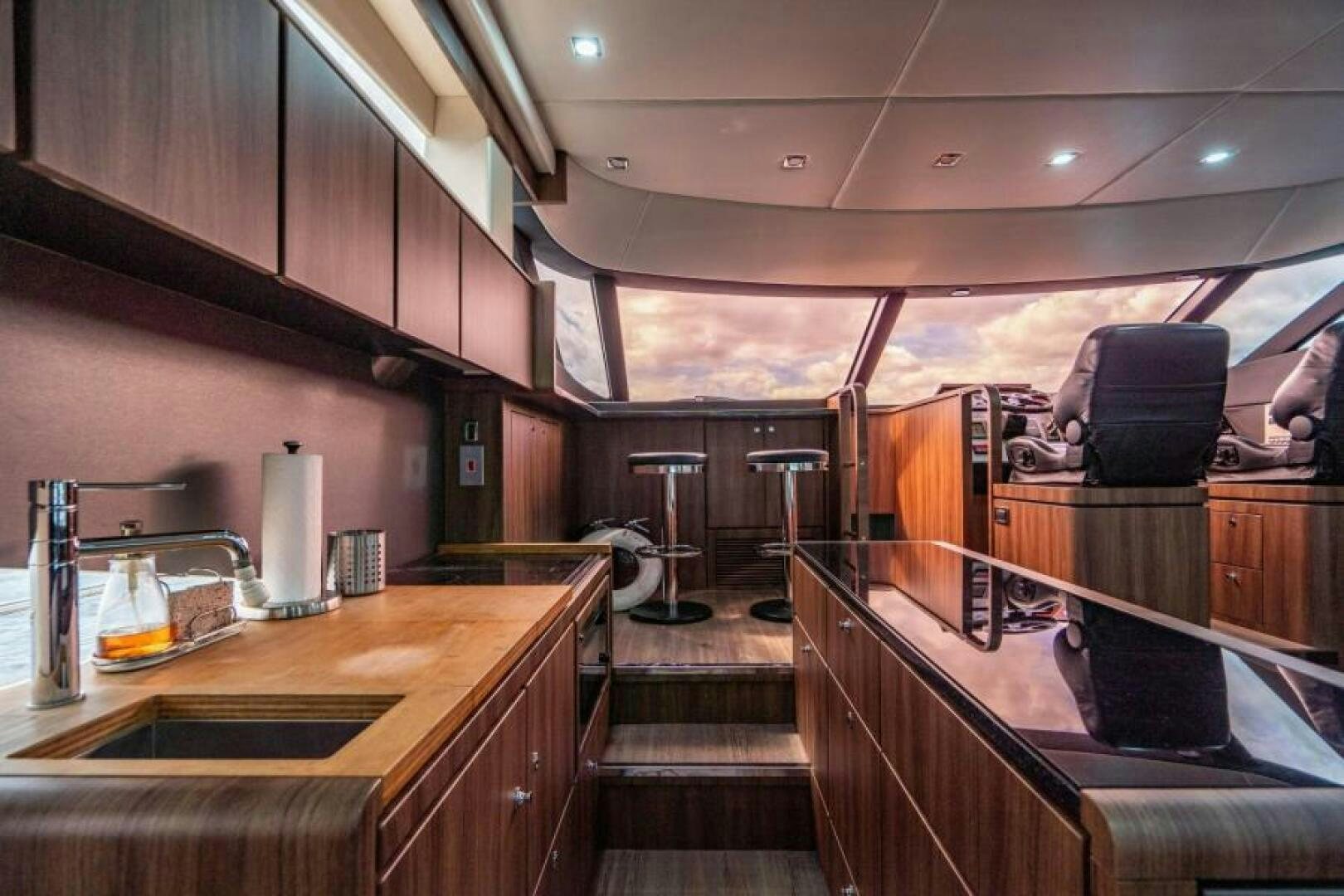 a bar with a bar and chairs aboard AQUABELLA Yacht for Sale