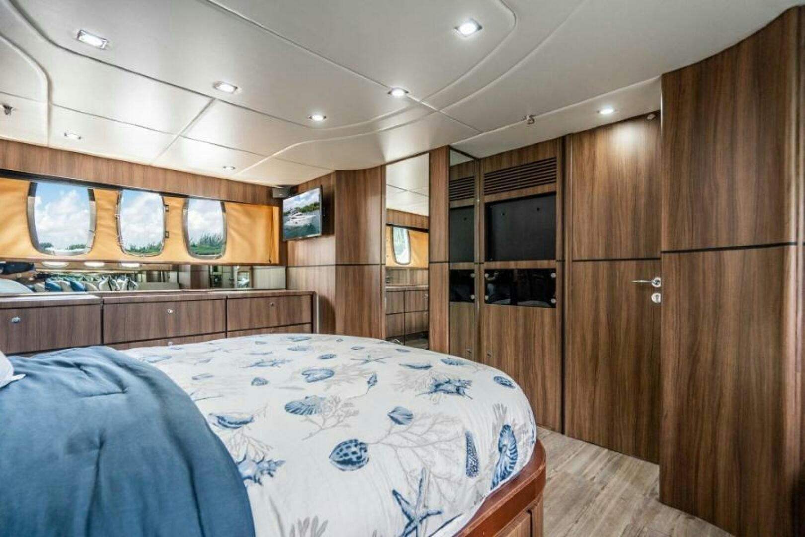 a bedroom with wood cabinets aboard AQUABELLA Yacht for Sale