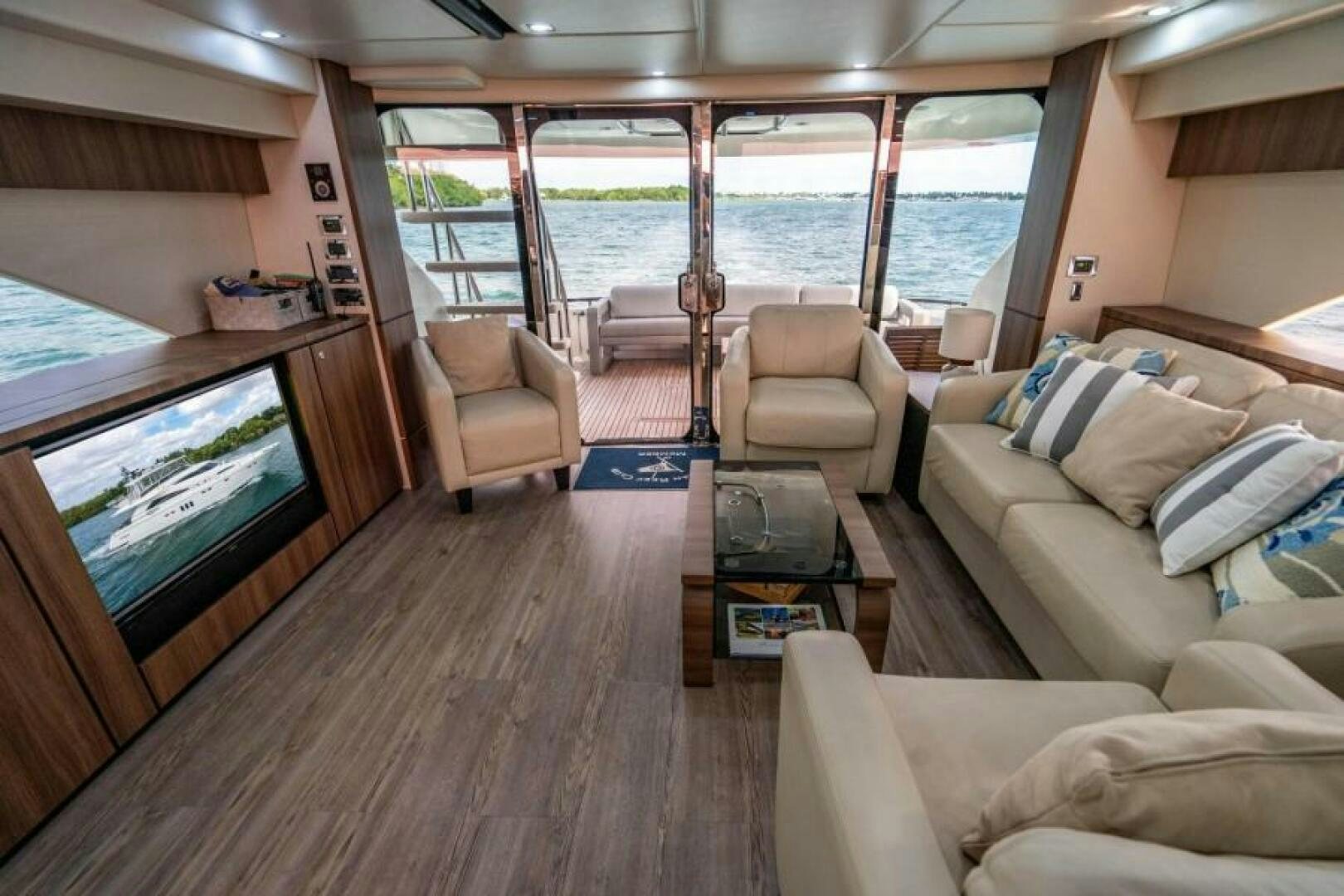 a living room with a large window aboard AQUABELLA Yacht for Sale