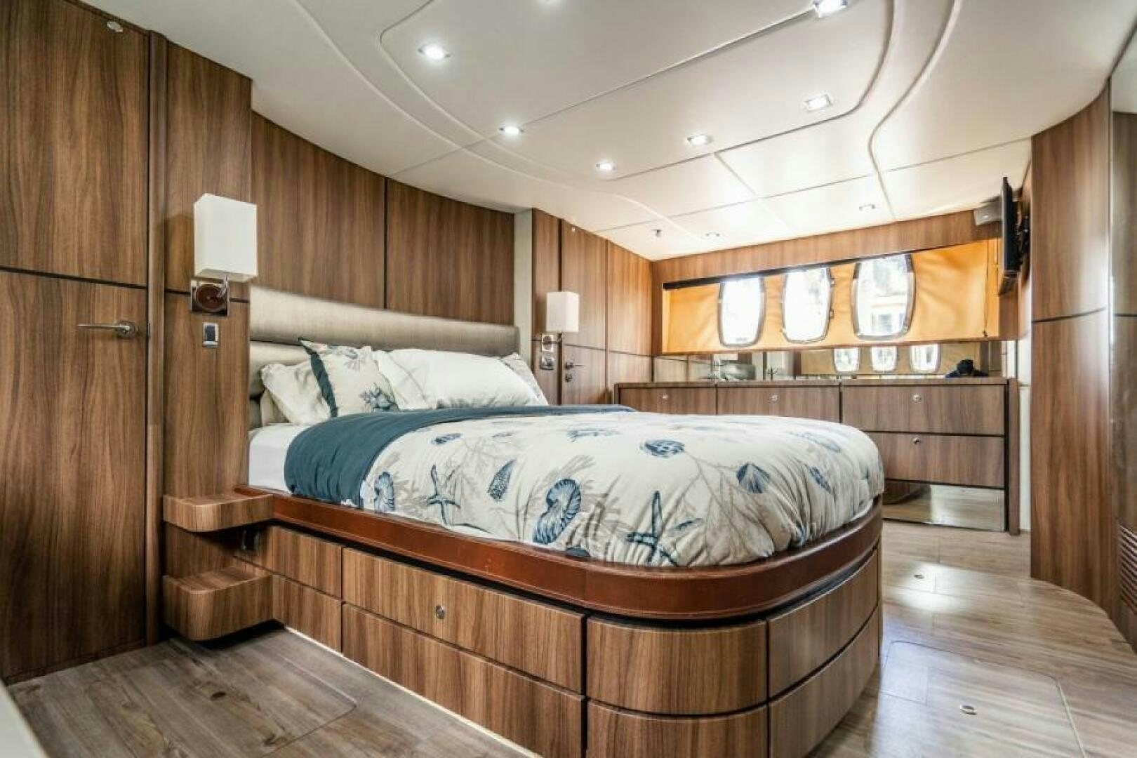 a room with a bed and a wood wall aboard AQUABELLA Yacht for Sale