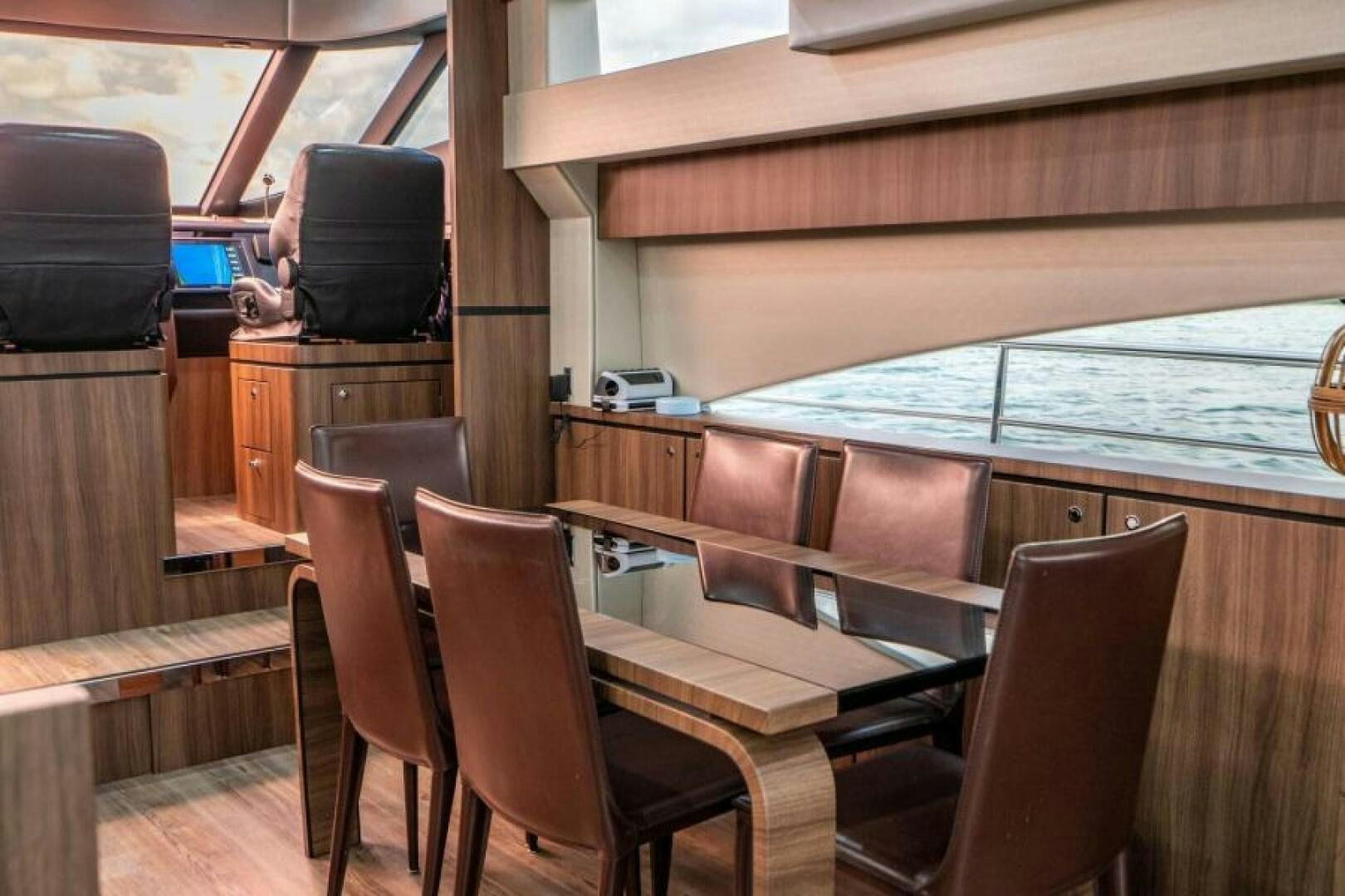 a room with a table and chairs aboard AQUABELLA Yacht for Sale