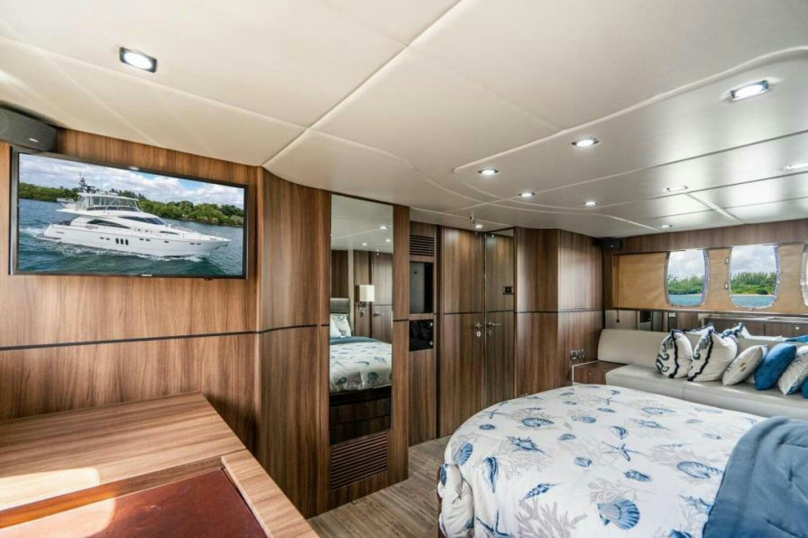a room with a bed and a wood wall aboard AQUABELLA Yacht for Sale