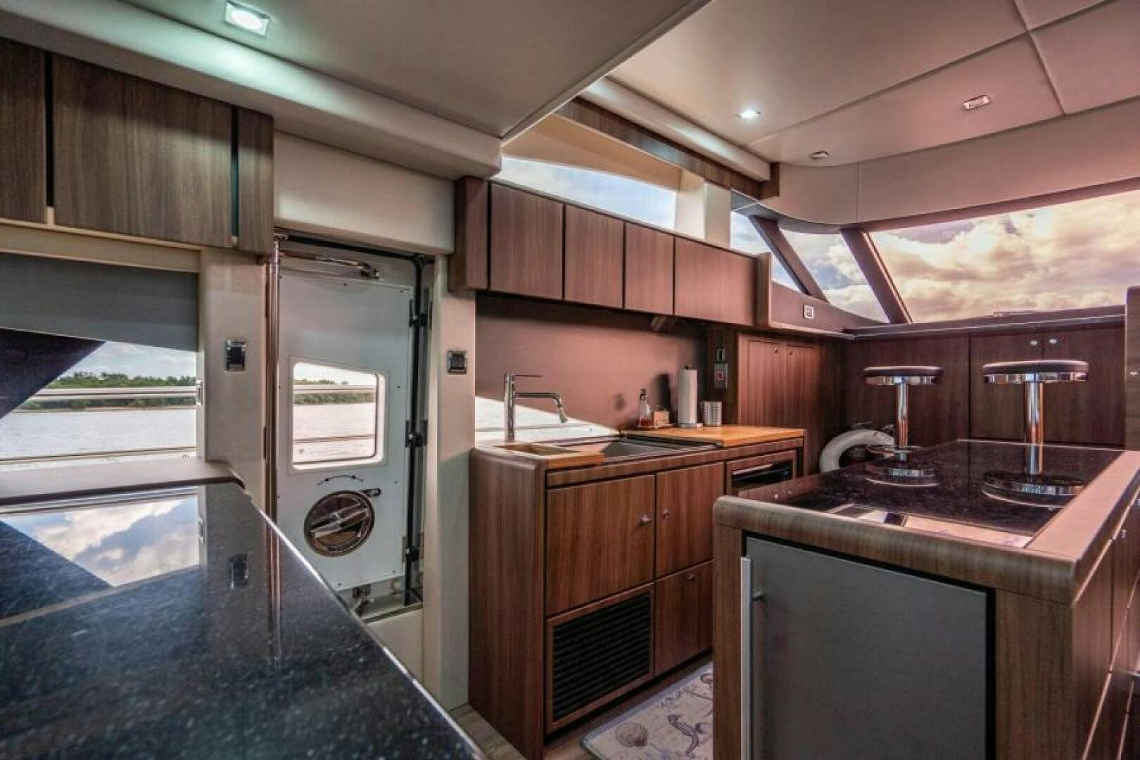 a kitchen with a large refrigerator aboard AQUABELLA Yacht for Sale