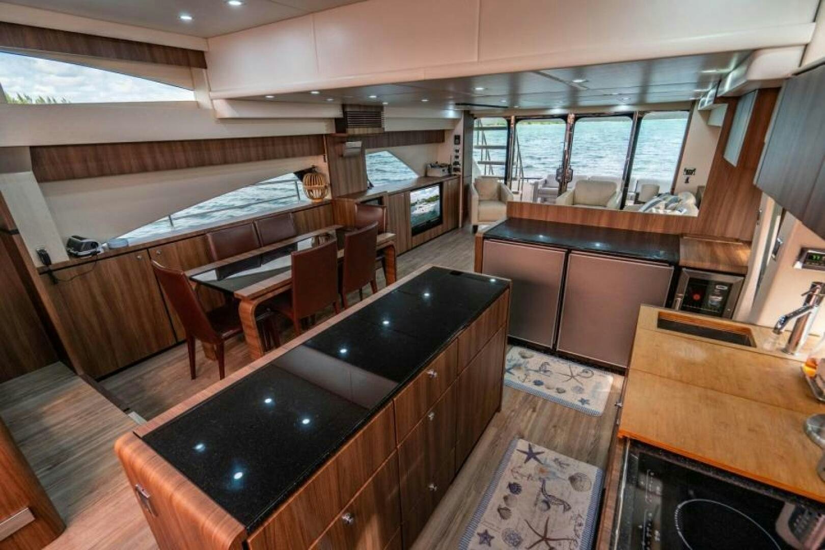 a large kitchen with a bar and bar aboard AQUABELLA Yacht for Sale