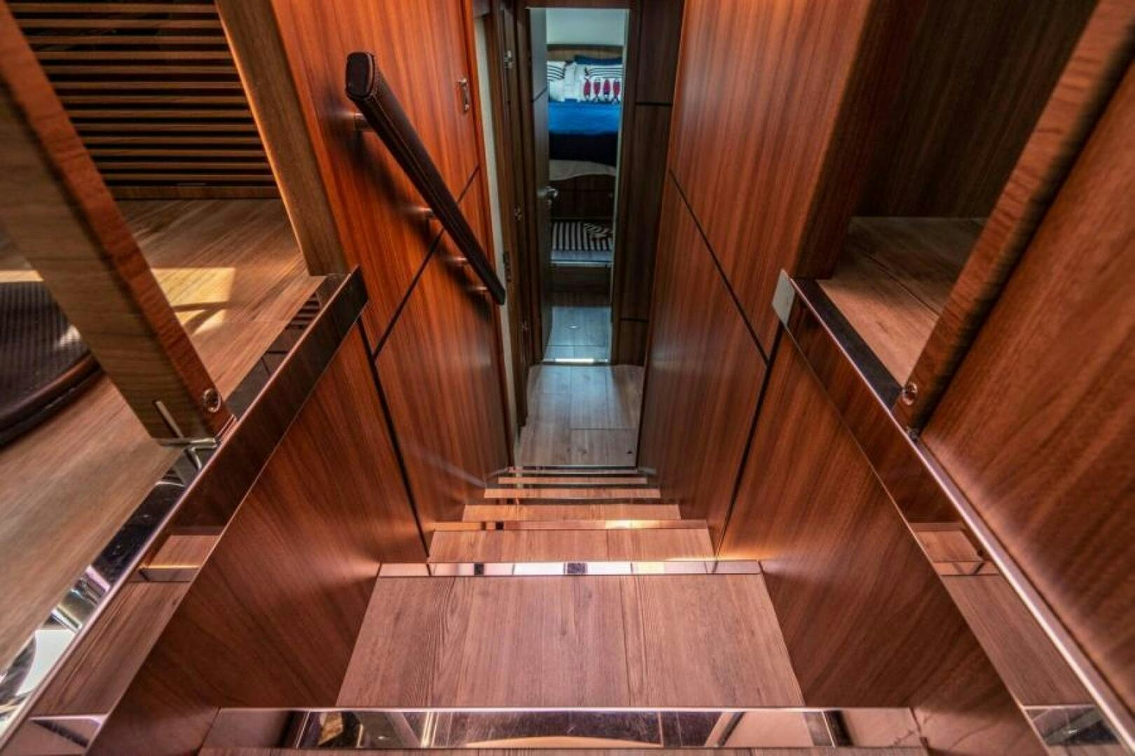 a wooden staircase with a railing aboard AQUABELLA Yacht for Sale