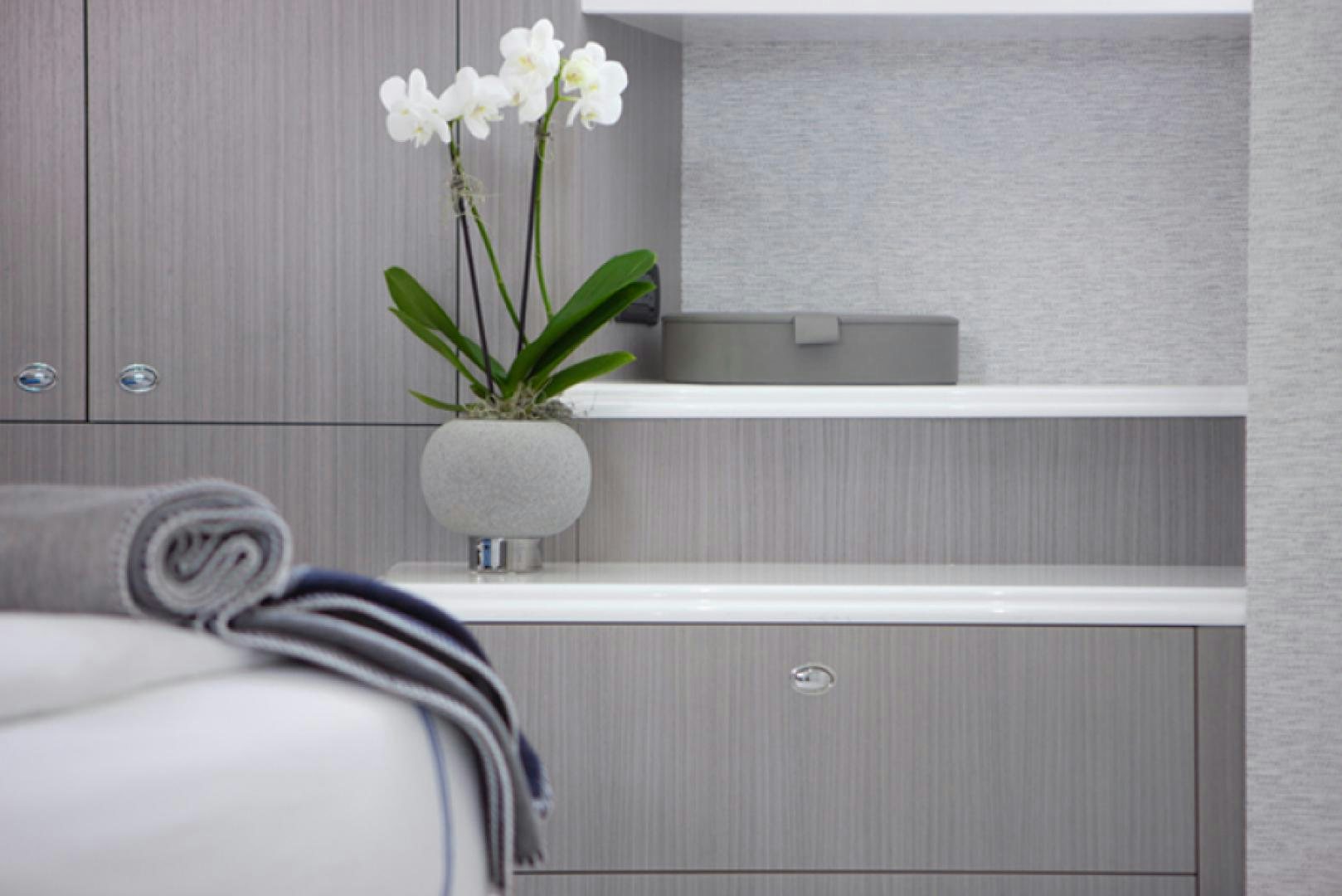 a vase of white flowers on a shelf aboard HANNAH Yacht for Sale