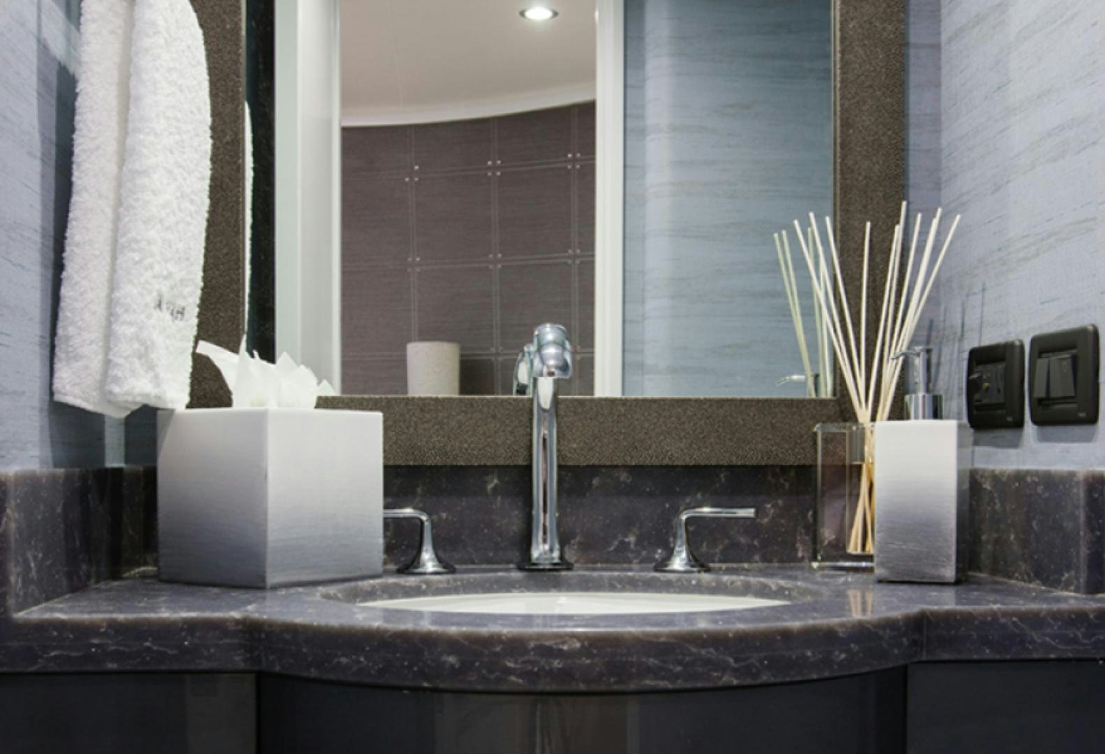 a bathroom sink with a towel and a mirror aboard HANNAH Yacht for Sale