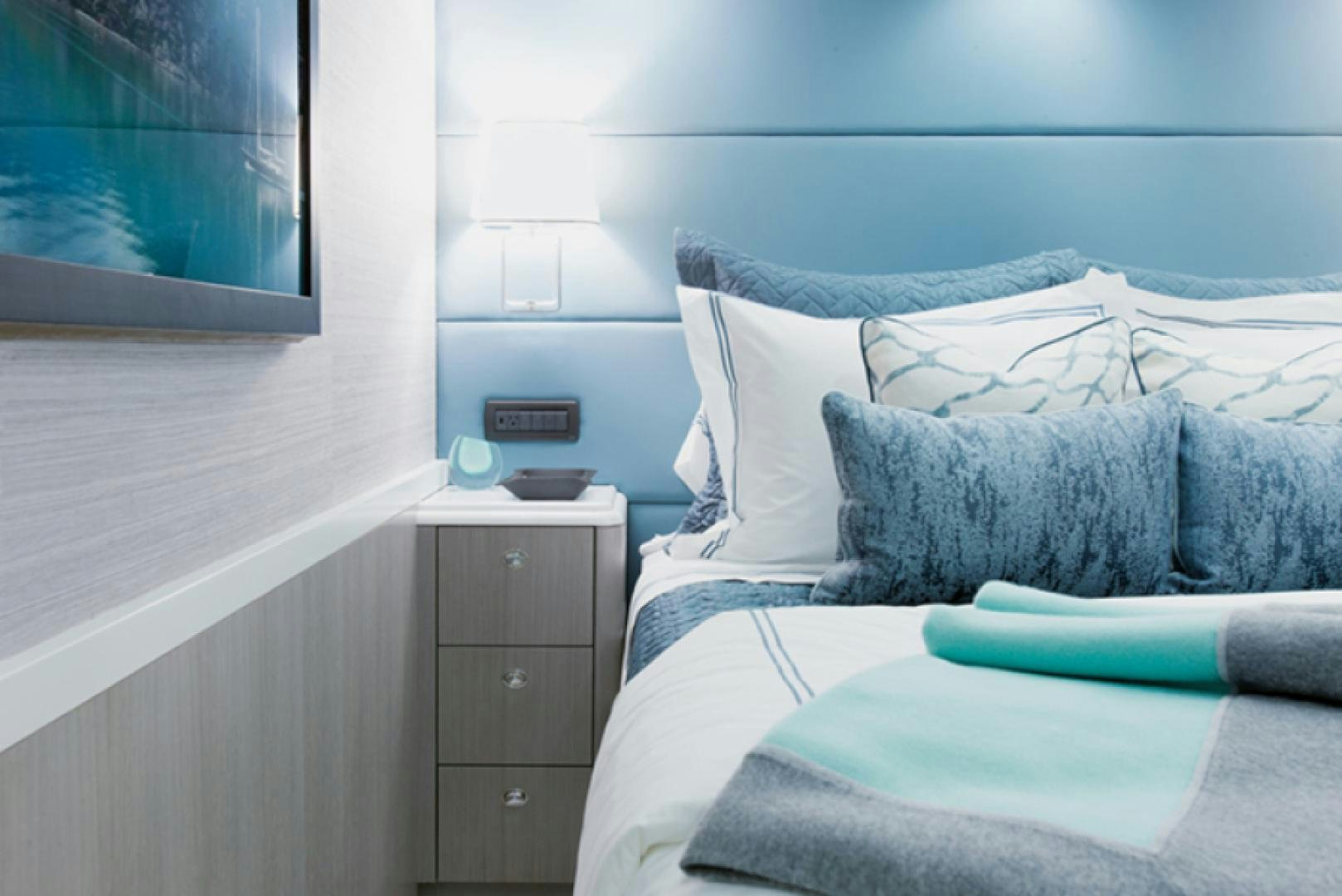 a bed with a blue pillow aboard HANNAH Yacht for Sale