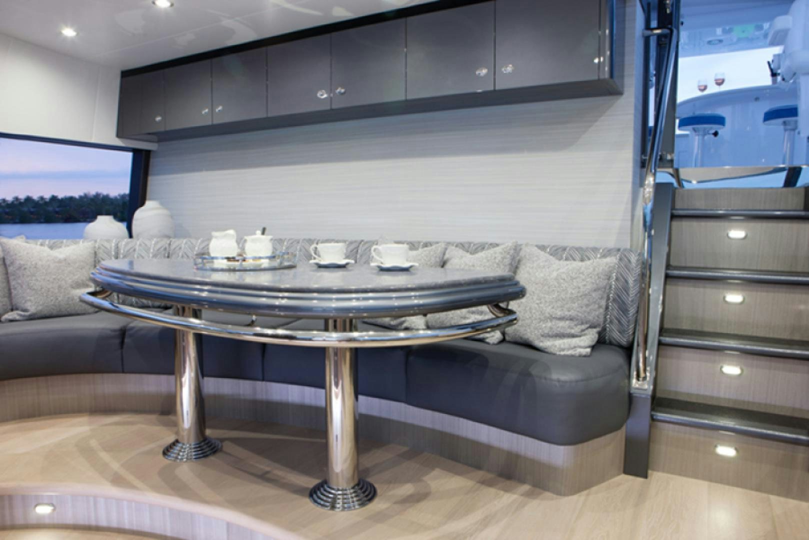 a living room with a table and couches aboard HANNAH Yacht for Sale