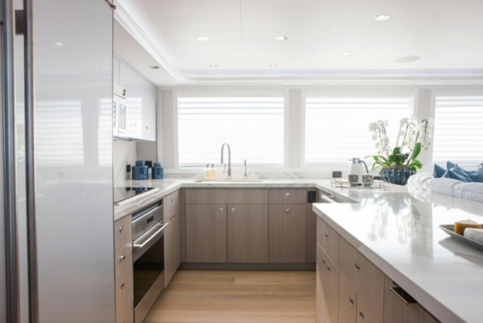 a kitchen with white cabinets aboard HANNAH Yacht for Sale