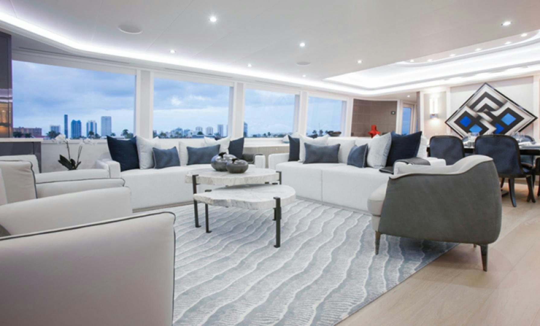 a room with a couch and a table and a large window aboard HANNAH Yacht for Sale
