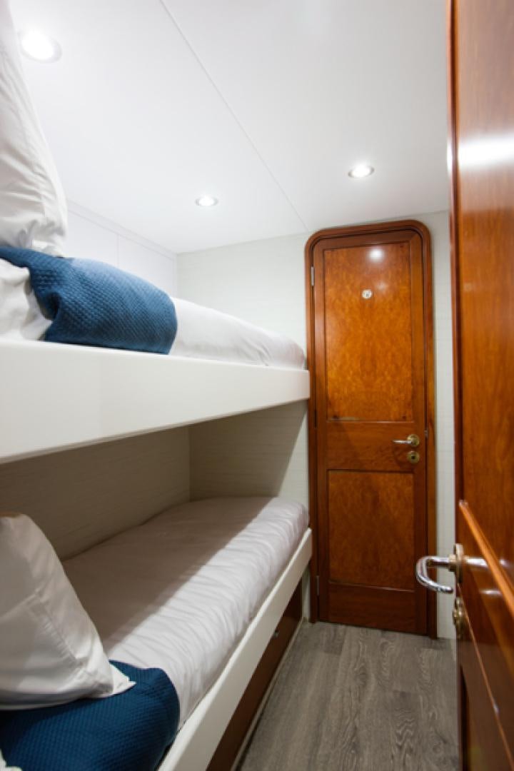 a room with a bed and a dresser aboard HANNAH Yacht for Sale