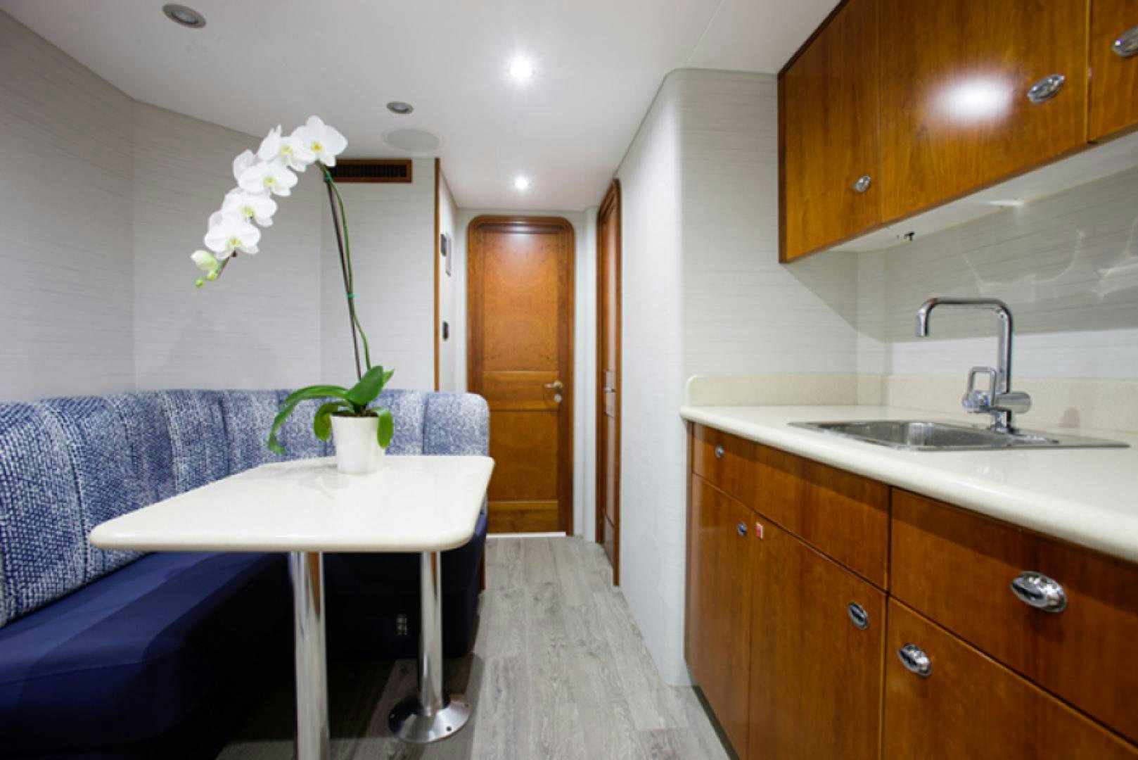 a kitchen with a table and a couch aboard HANNAH Yacht for Sale