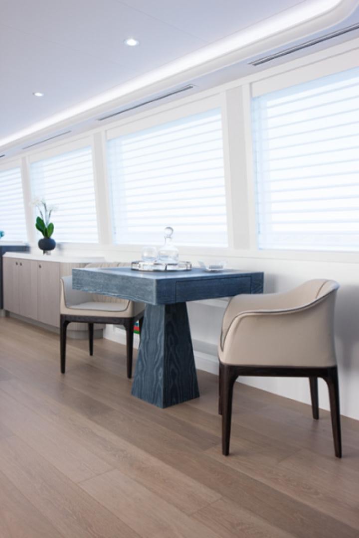 a table and chairs in a room aboard HANNAH Yacht for Sale