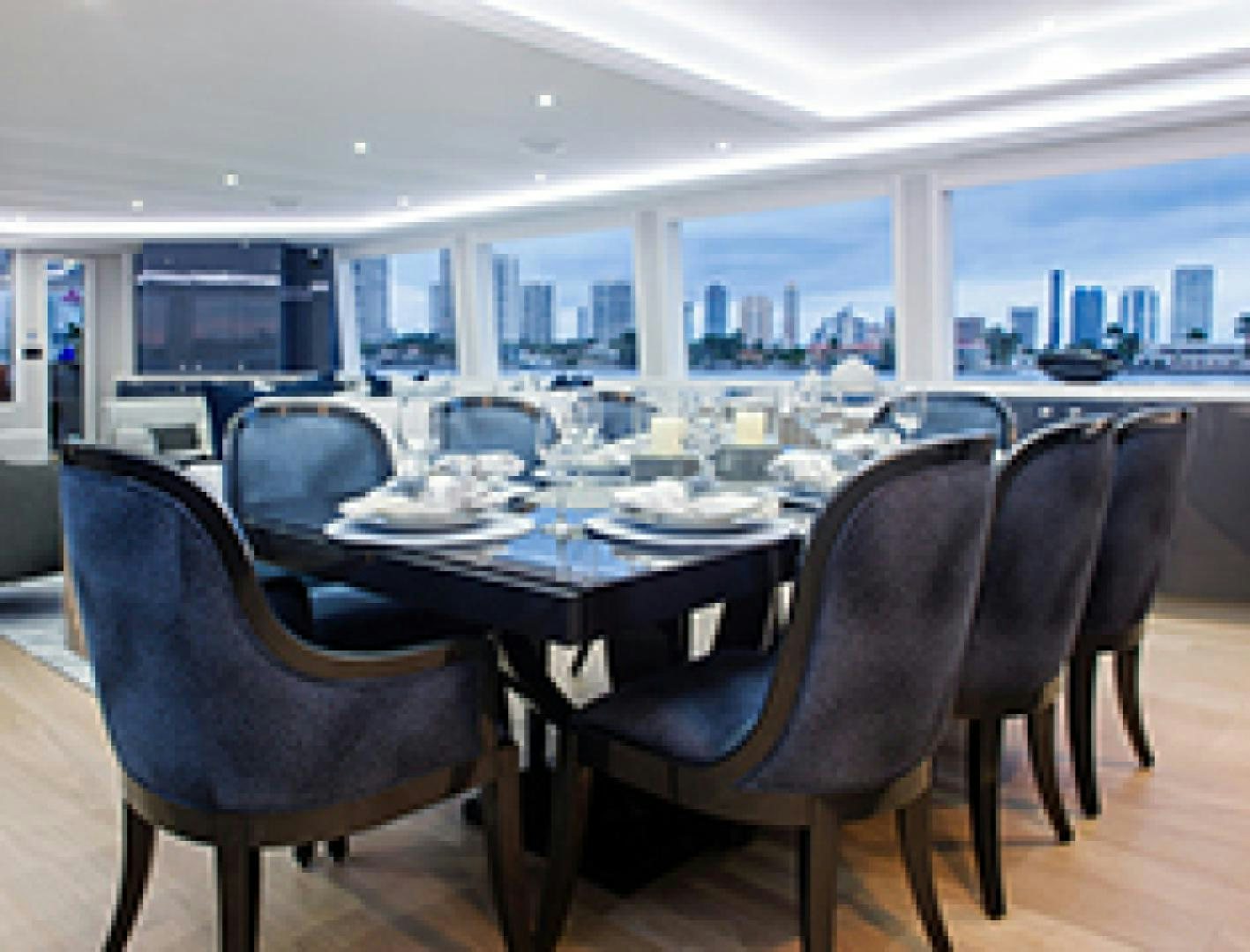 a large room with a table and chairs aboard HANNAH Yacht for Sale