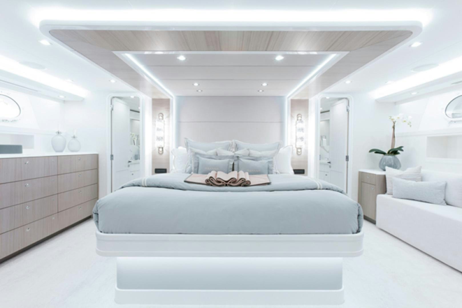 a white bedroom with a white couch aboard HANNAH Yacht for Sale