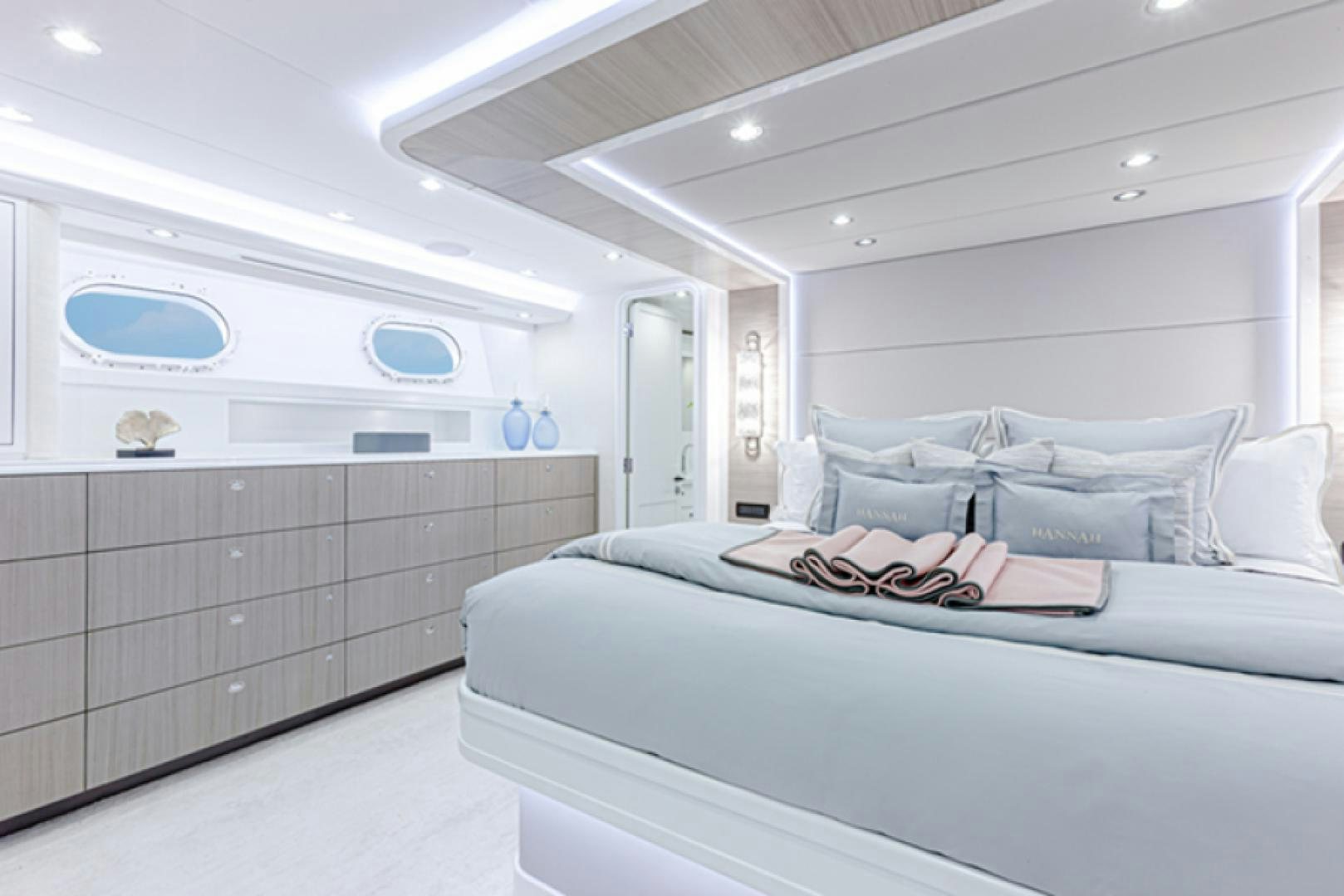 a room with a bed and a dresser aboard HANNAH Yacht for Sale