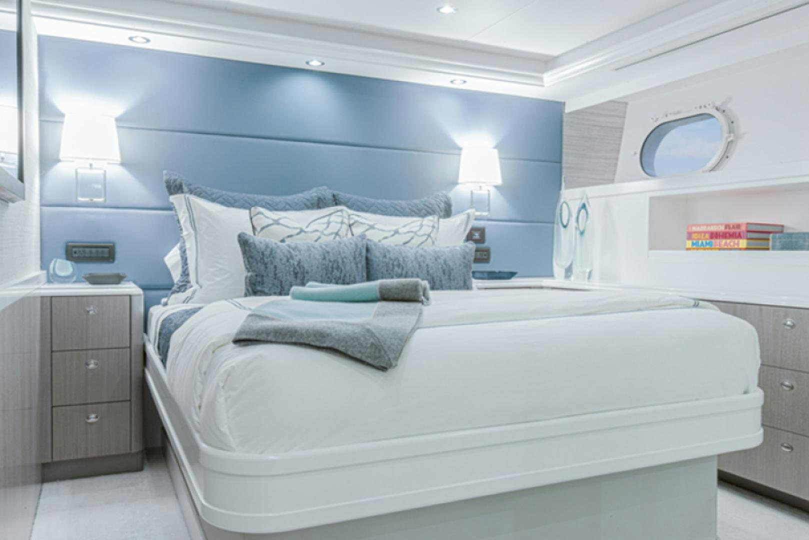 a bed with blue sheets aboard HANNAH Yacht for Sale