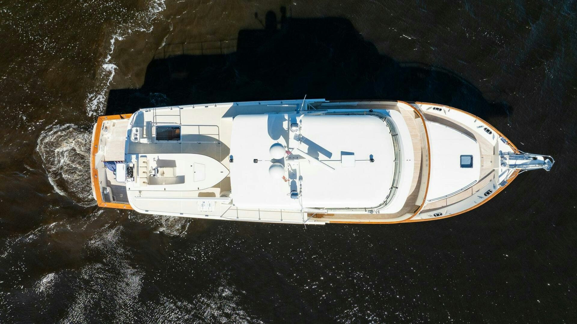 a white and orange boat on a rocky surface aboard BEBA Yacht for Sale