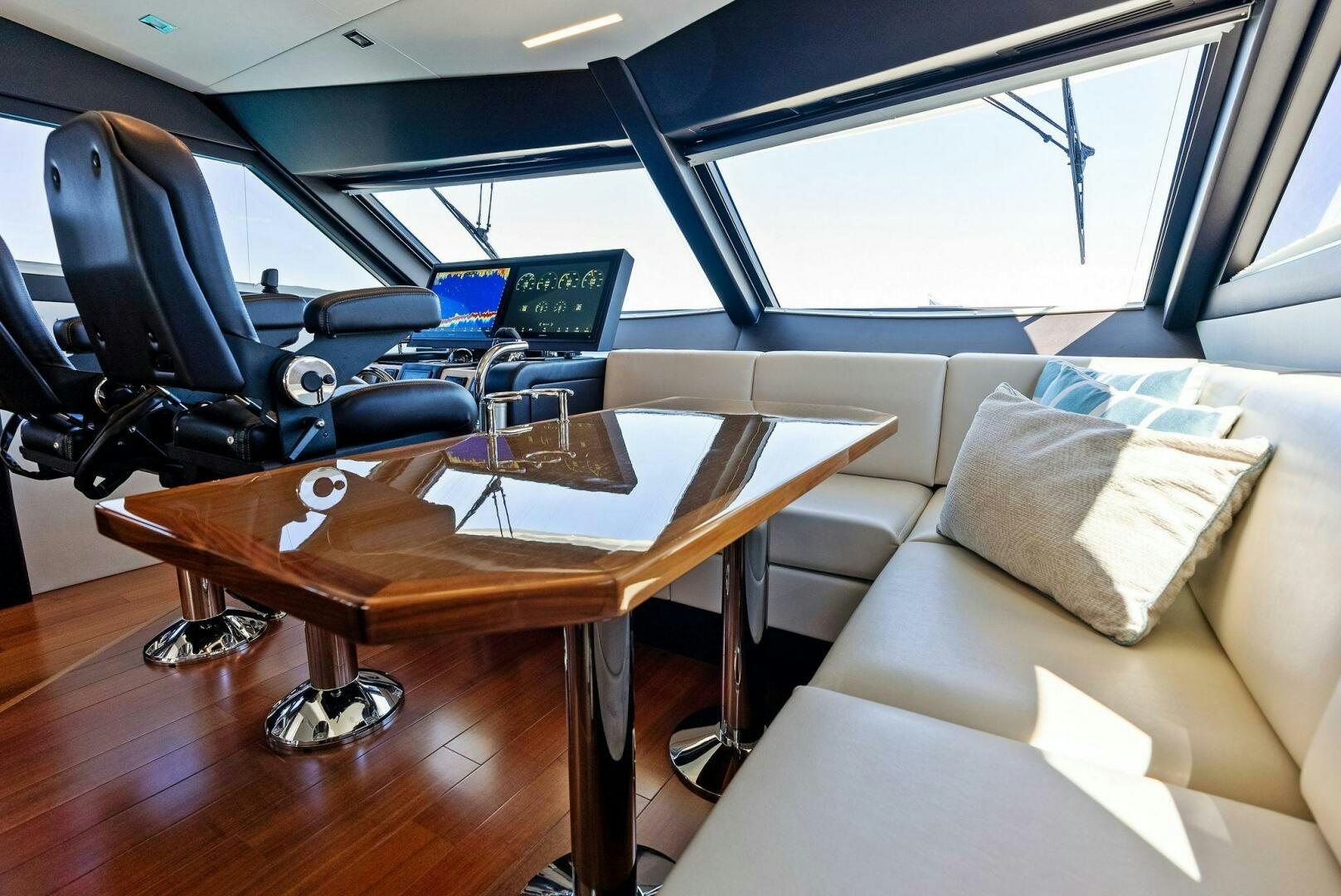 a table with a chair and a couch in a room with a window aboard SUNNY SEAJAY Yacht for Sale