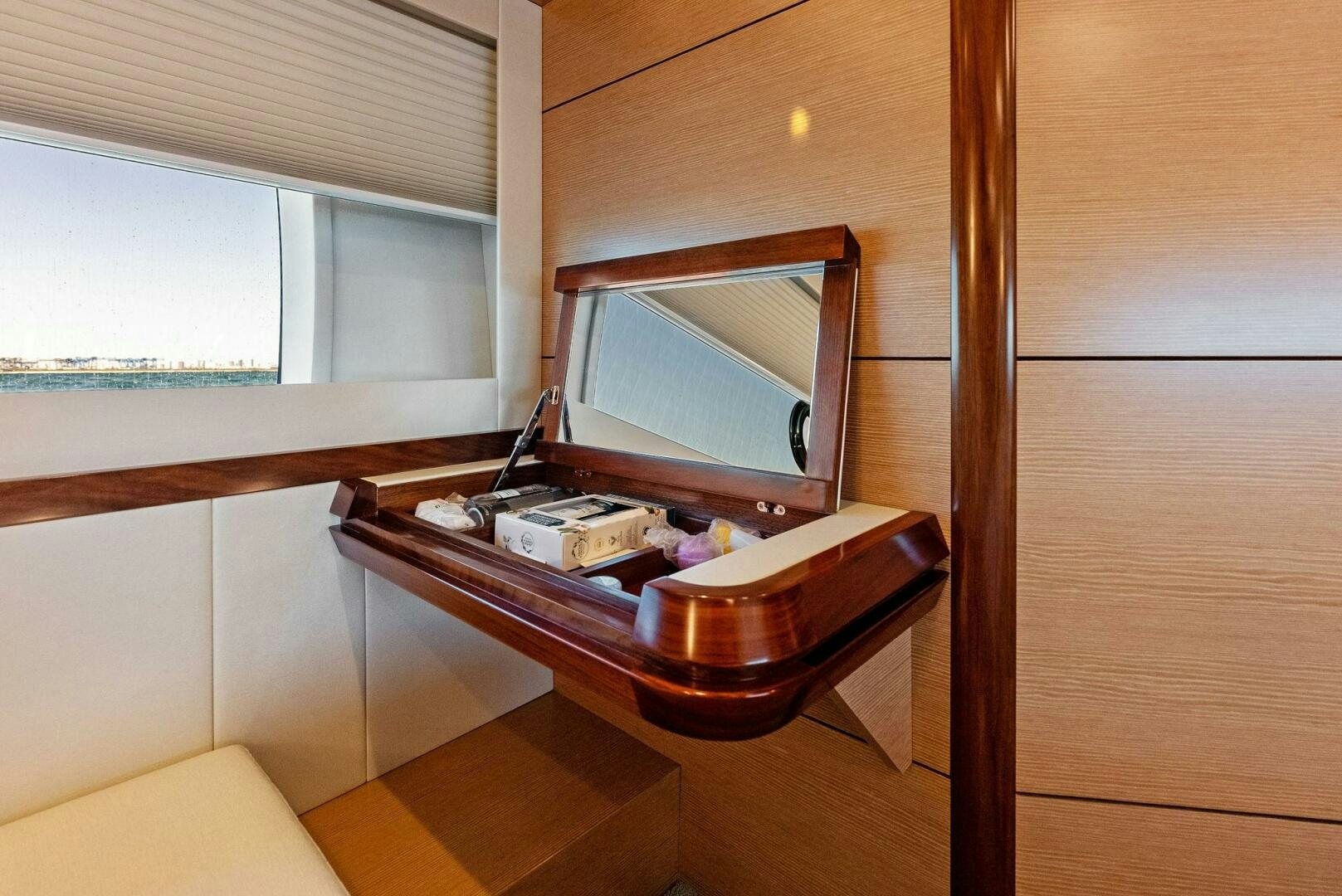 a desk with a mirror and a bed aboard SUNNY SEAJAY Yacht for Sale