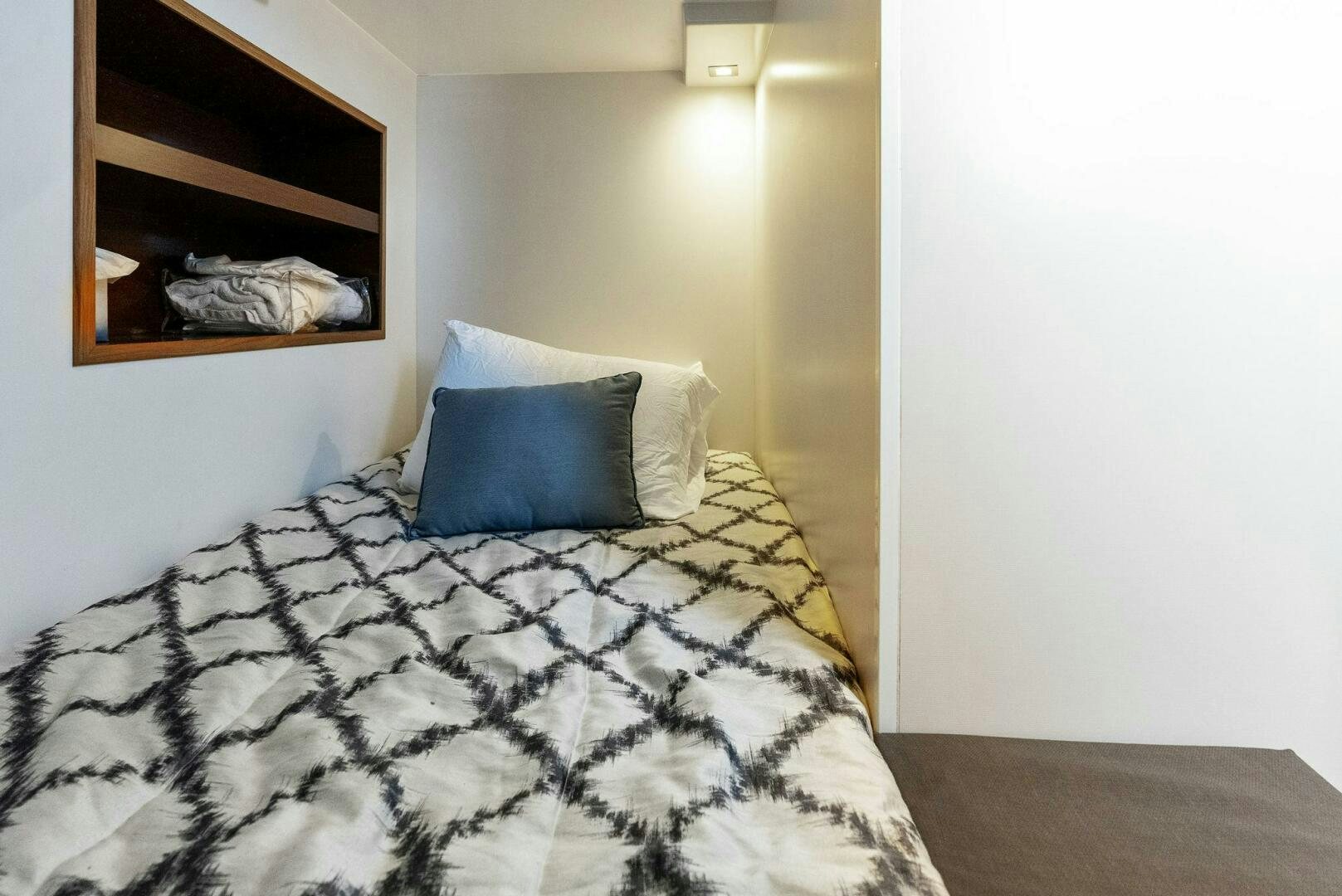 a bed with a white pillow aboard SUNNY SEAJAY Yacht for Sale