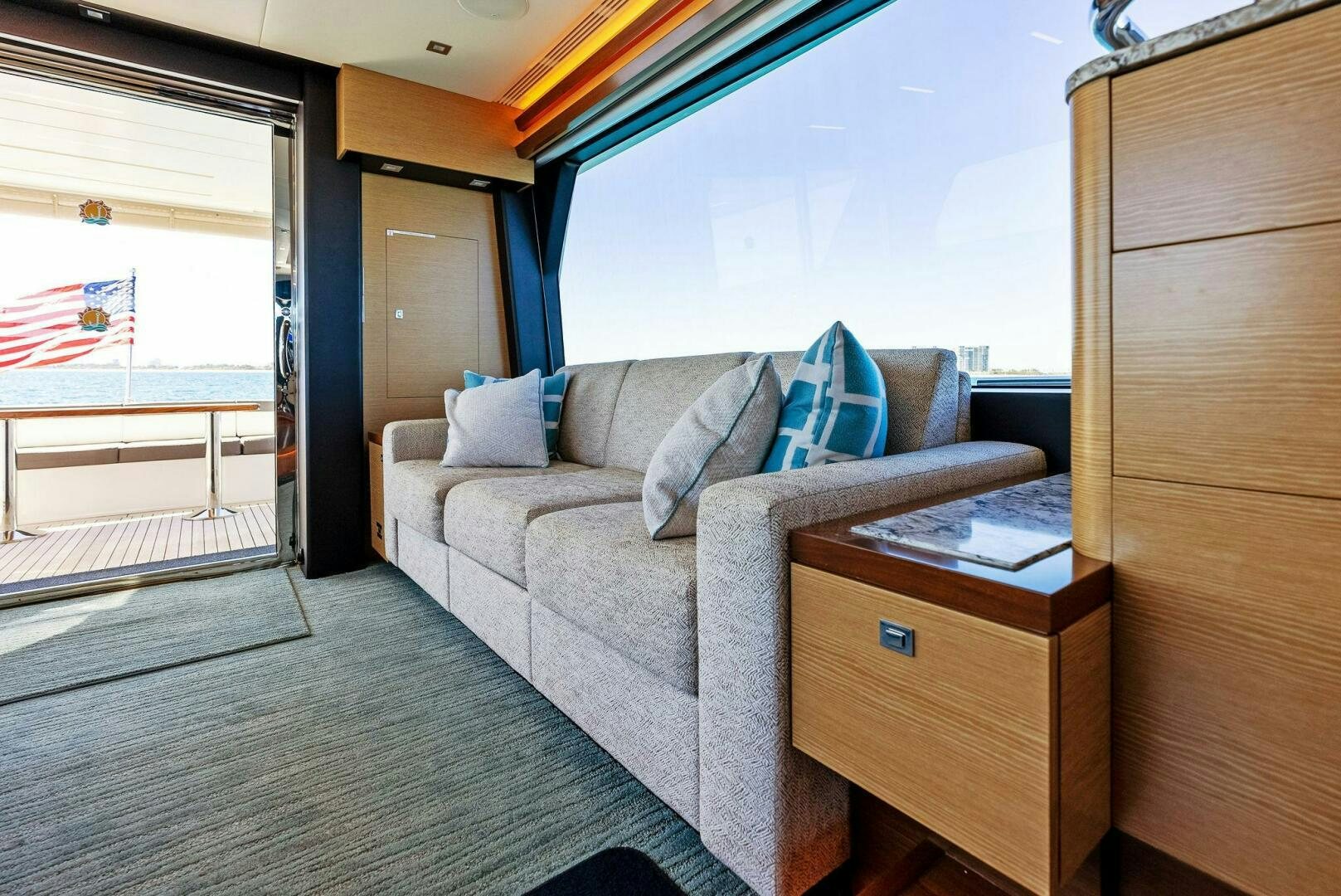 a living room with a couch and a window aboard SUNNY SEAJAY Yacht for Sale