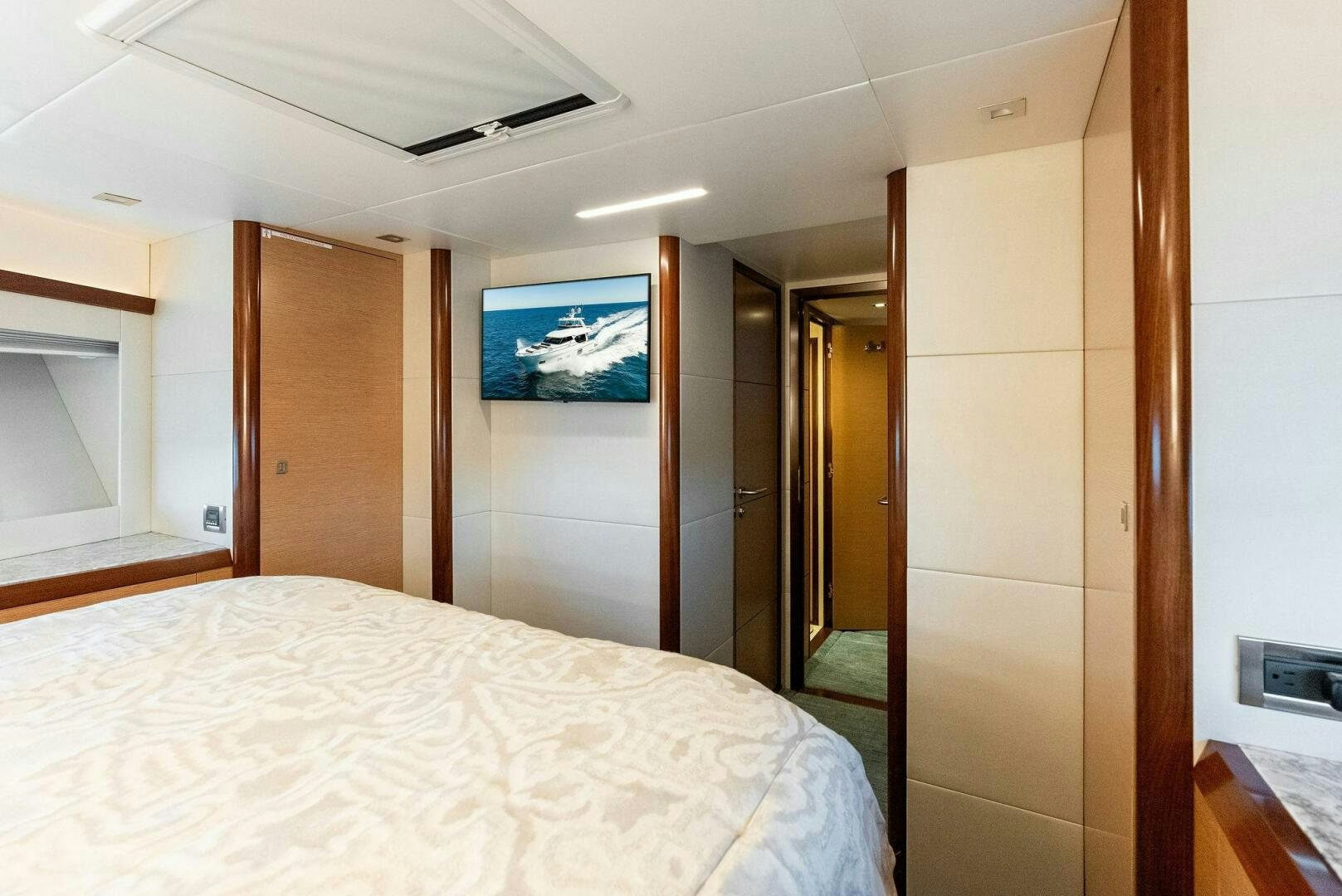 a bedroom with a bed and a television on the wall aboard SUNNY SEAJAY Yacht for Sale