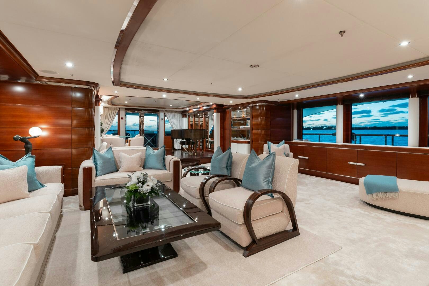 a room with a couch and a coffee table aboard Q Yacht for Sale