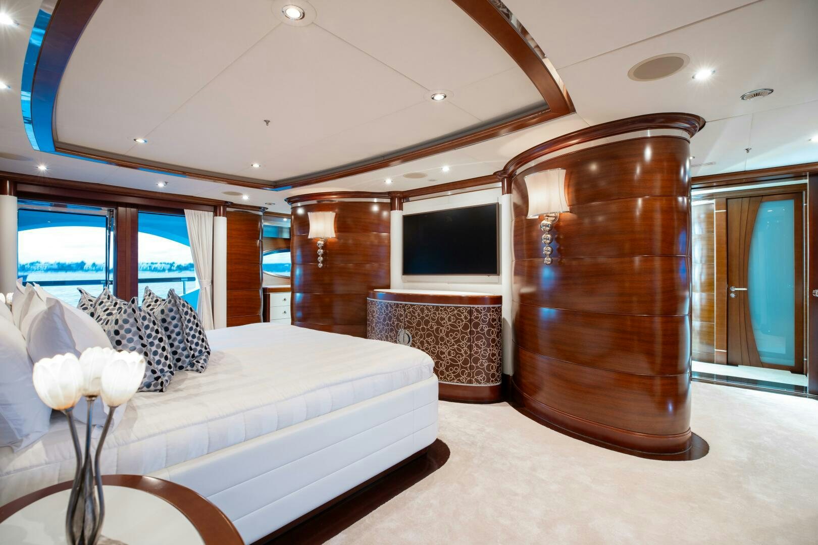 a hotel room with a bed and a tv aboard Q Yacht for Sale