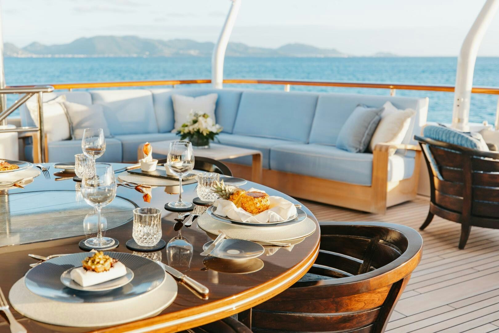 a table with plates and glasses on it aboard Q Yacht for Sale
