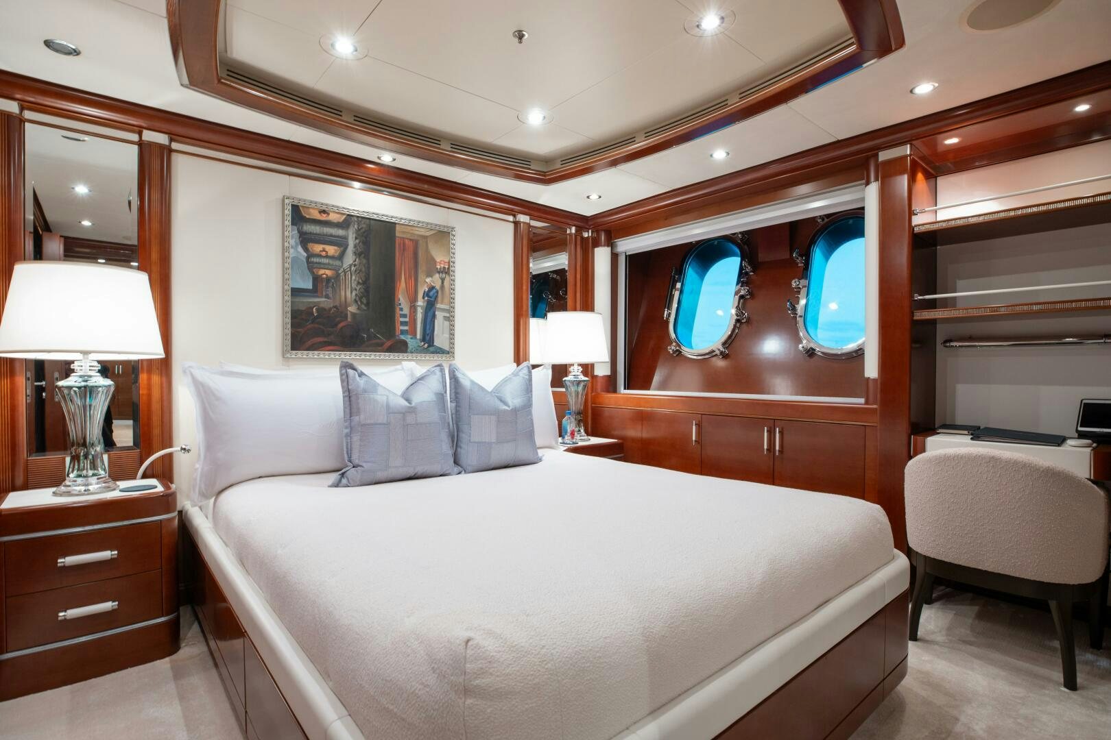 a bed with a white bed spread aboard Q Yacht for Sale