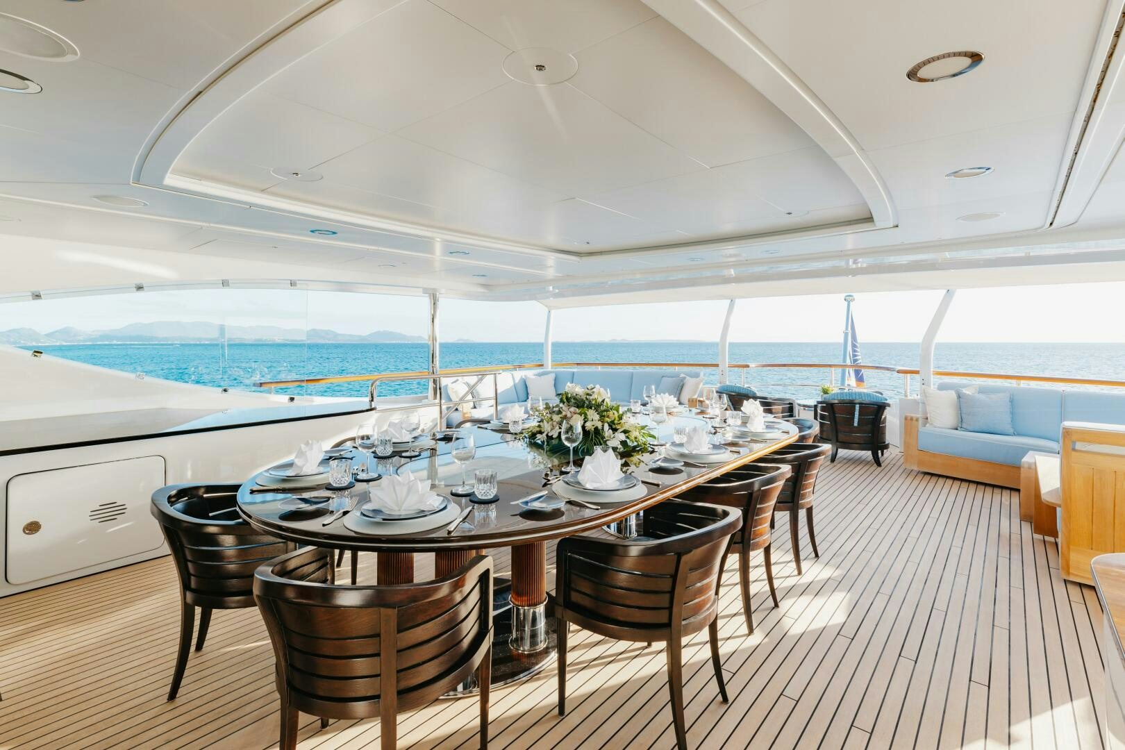 a dining table on a deck aboard Q Yacht for Sale