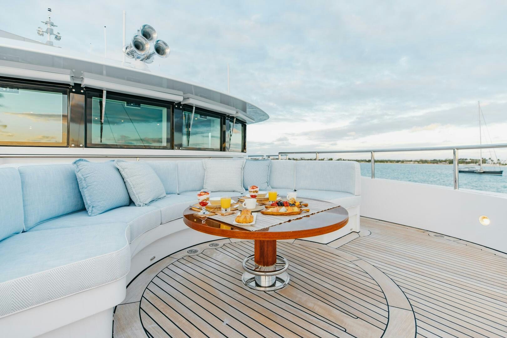 a living room with a couch and a table aboard Q Yacht for Sale
