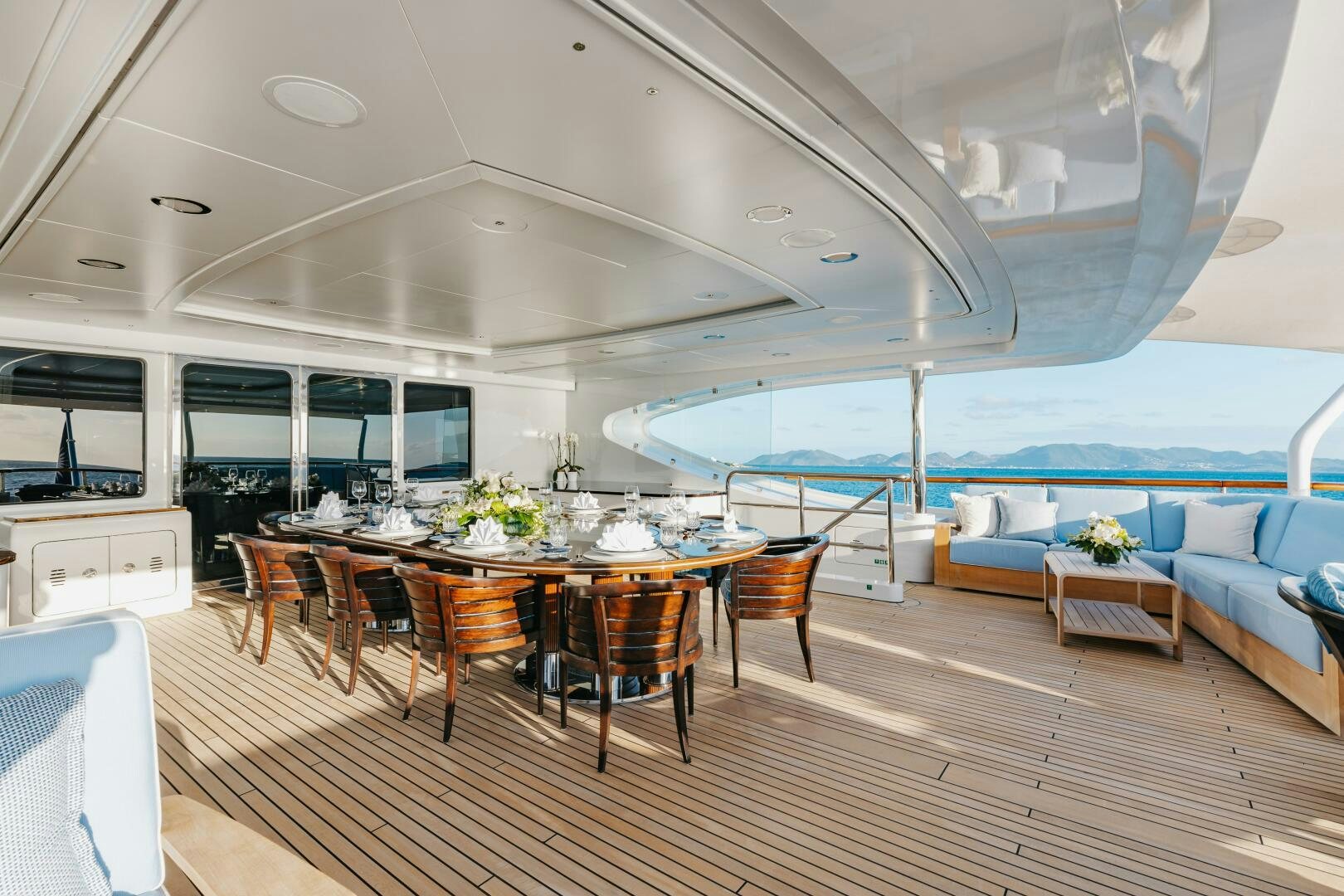 a room with a table and chairs aboard Q Yacht for Sale