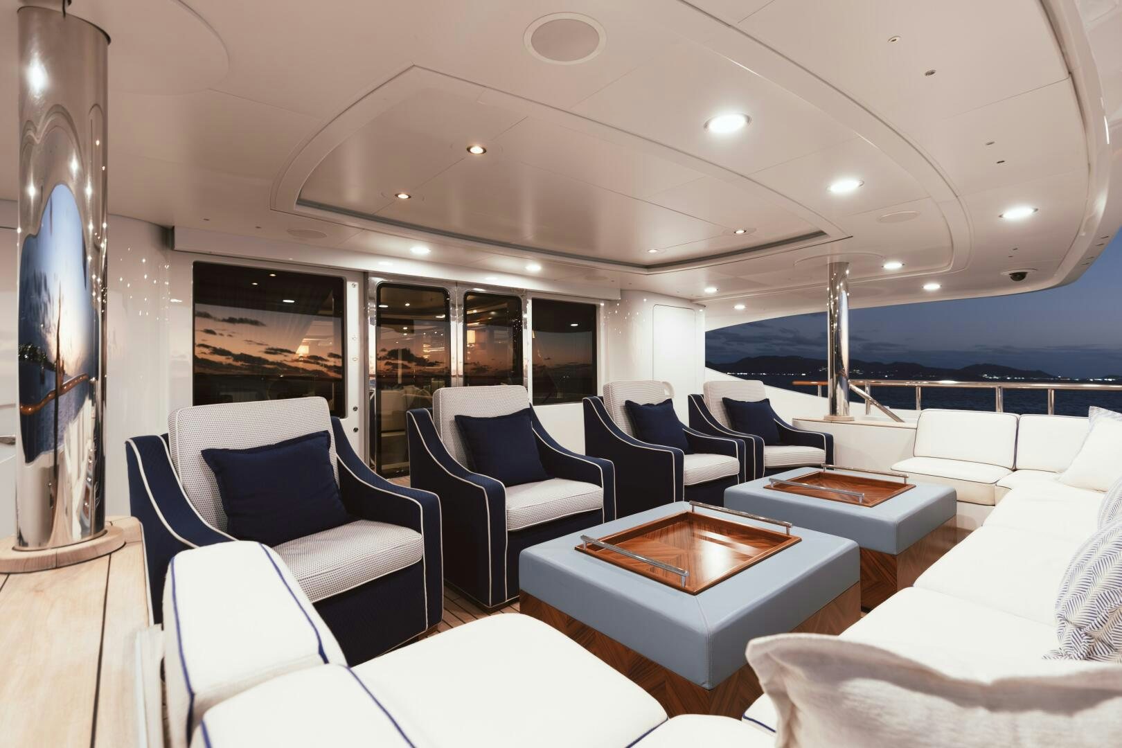 a room with chairs and tables aboard Q Yacht for Sale
