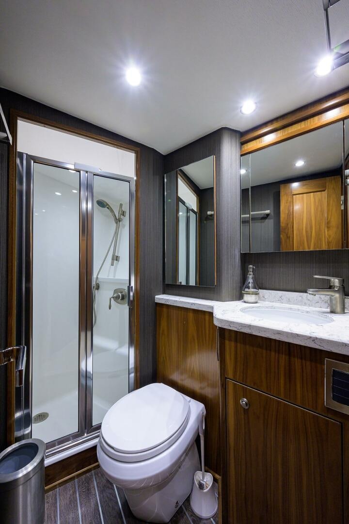 a bathroom with a glass shower door aboard SNOWBIRD Yacht for Sale